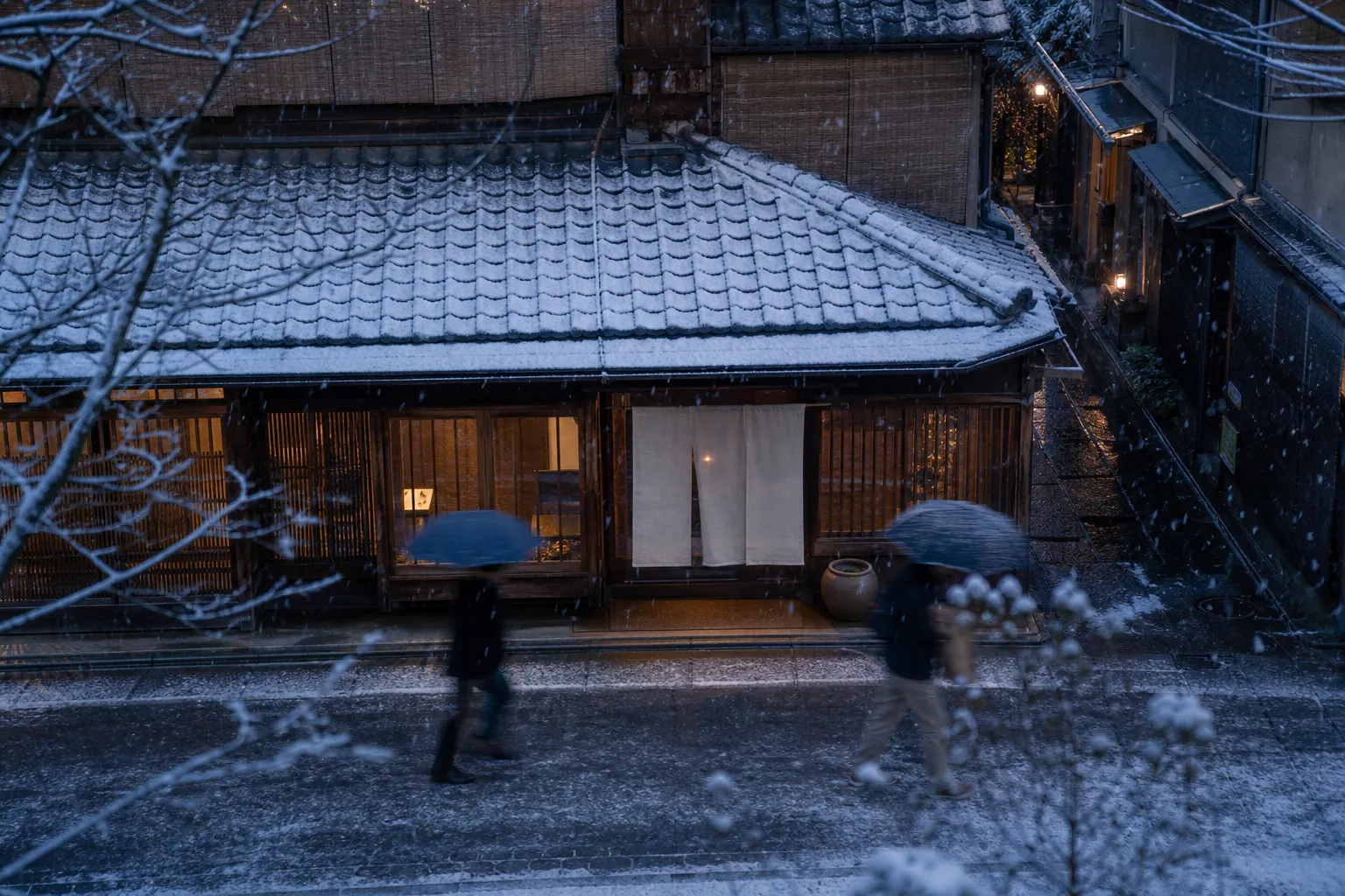 Traditional Kyoto specialty shop storefront with noren curtain on a quiet street