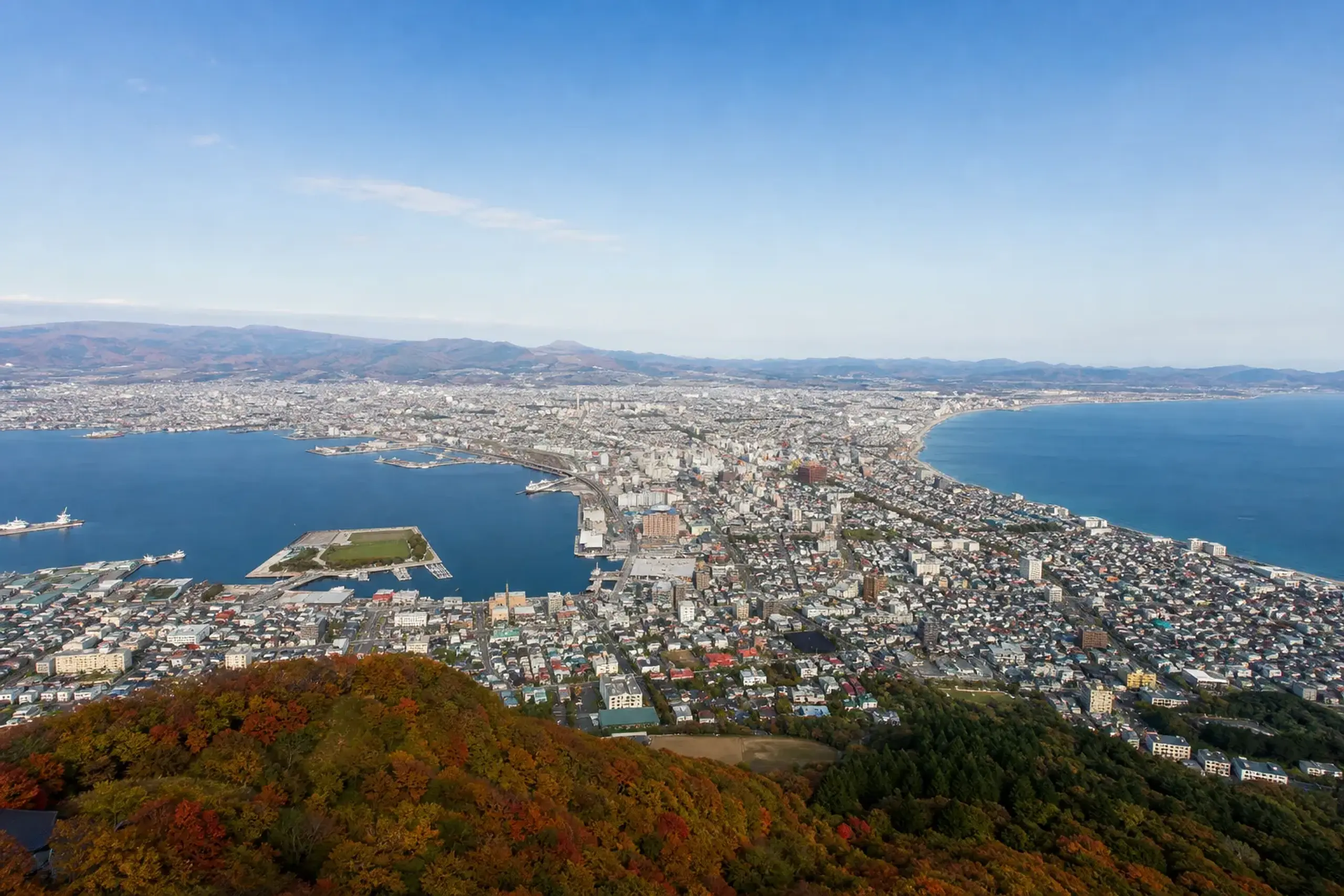 Daytime panorama from Mount Hakodate summit over the city and twin bays