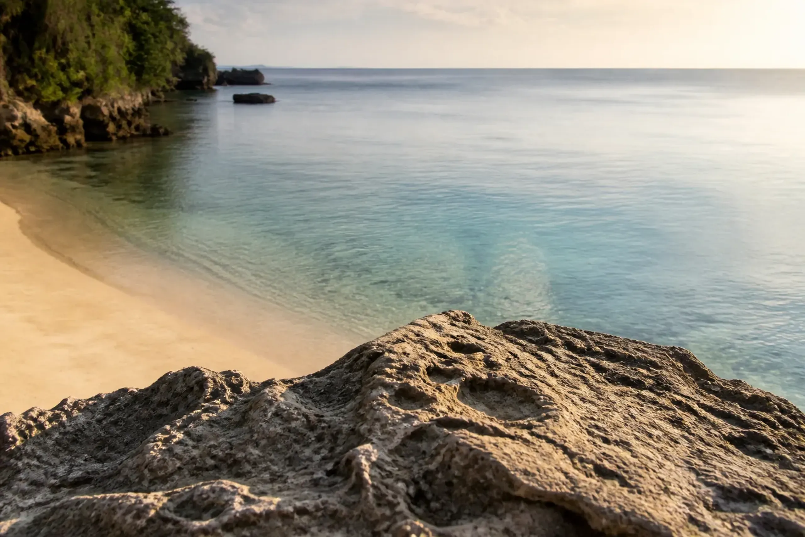 A quiet, empty stretch of southern Okinawa coastline with turquoise shallows