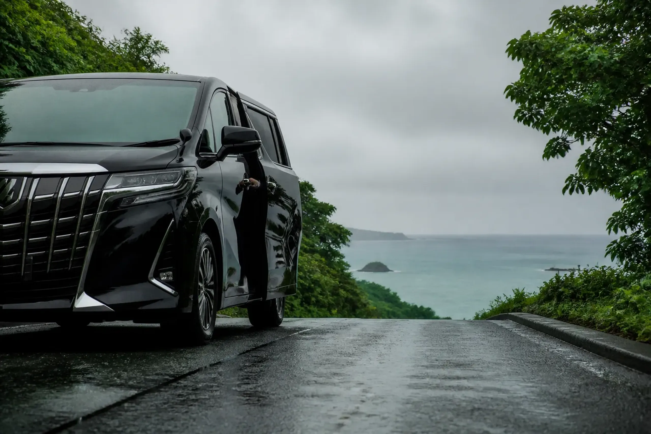 Private chauffeured Toyota Alphard on a coastal road in southern Okinawa