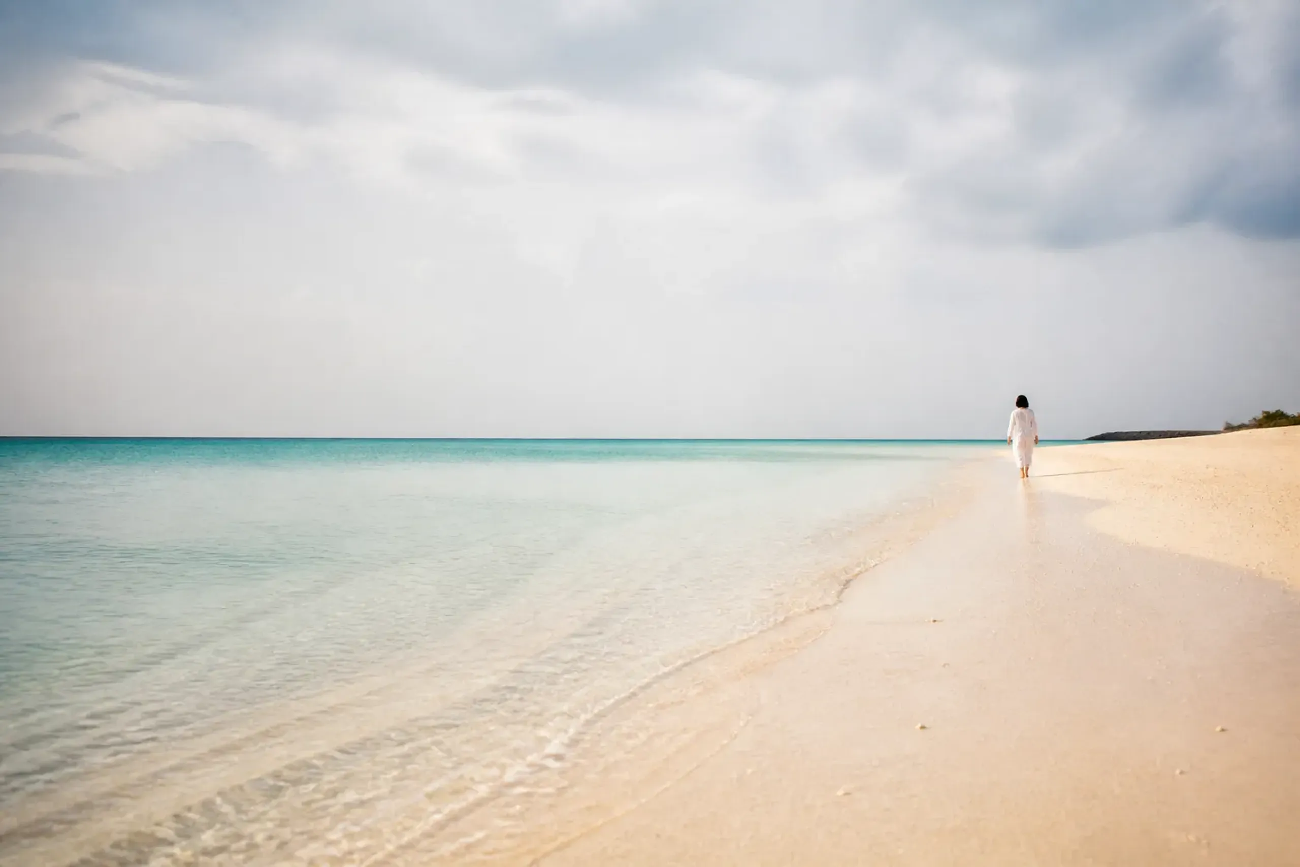 A quiet, empty stretch of southern Okinawa coastline with turquoise shallows