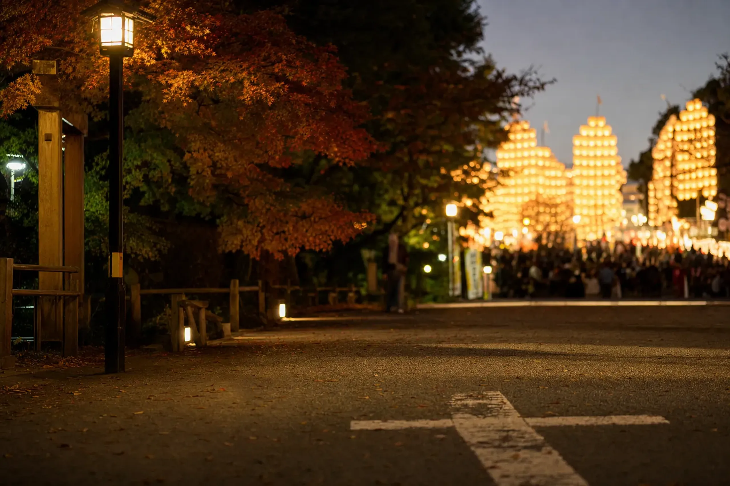 The long street of Kantō Ōdori at the edge of the festival crowd, marking a pre-decided post-performance meeting point as lanterns tower in the distance