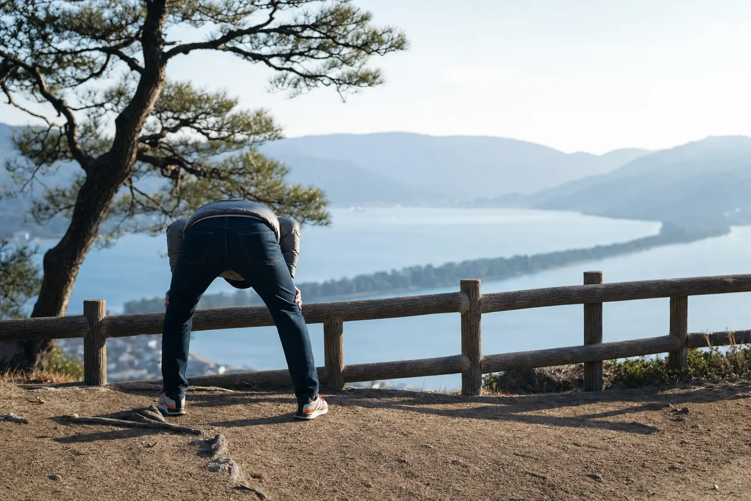 Visitor performing the matanozoki custom, viewing the Amanohashidate sandbar upside down from Kasamatsu Park