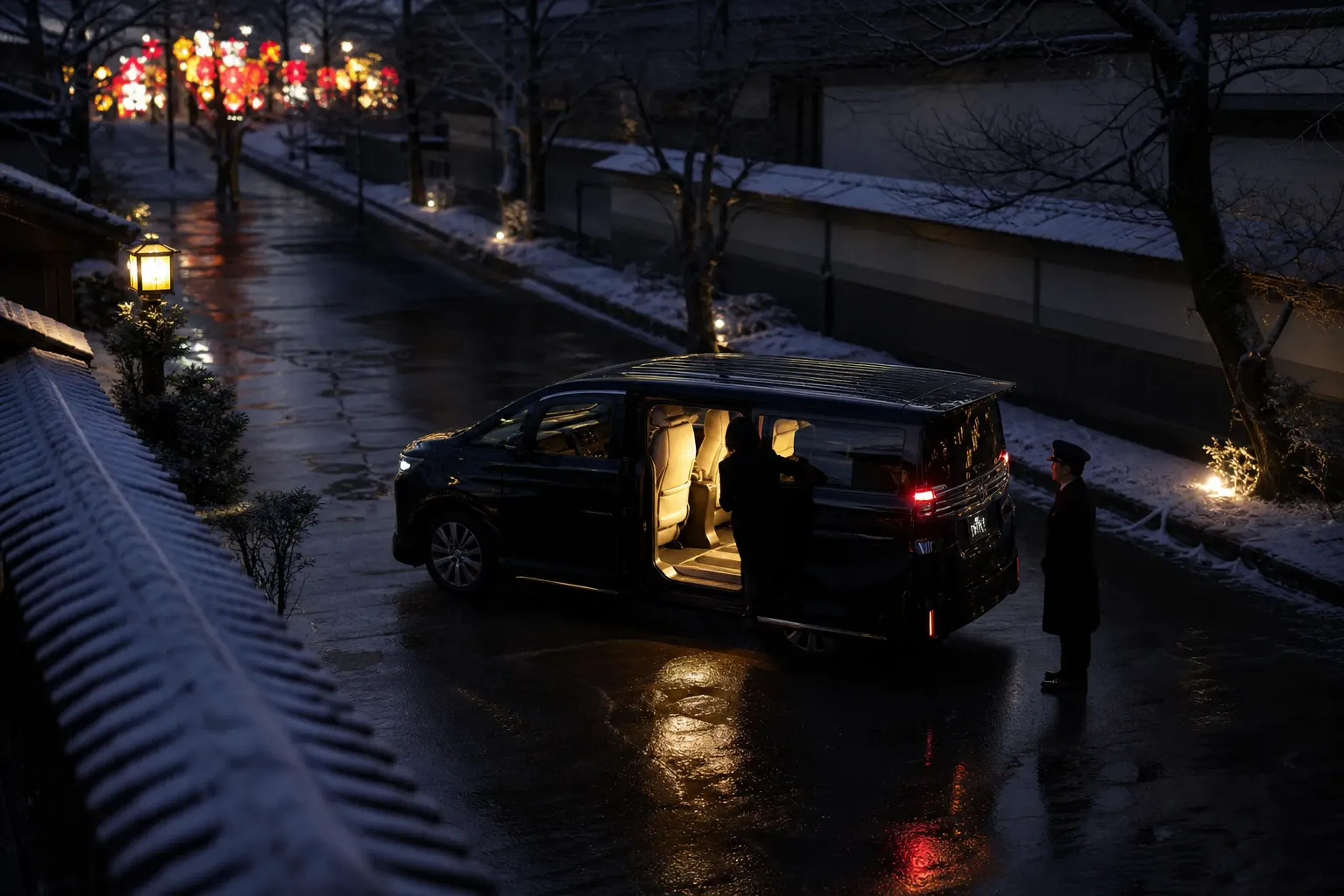 Chauffeured private vehicle arrival in Aomori at night with festival lights in the distance