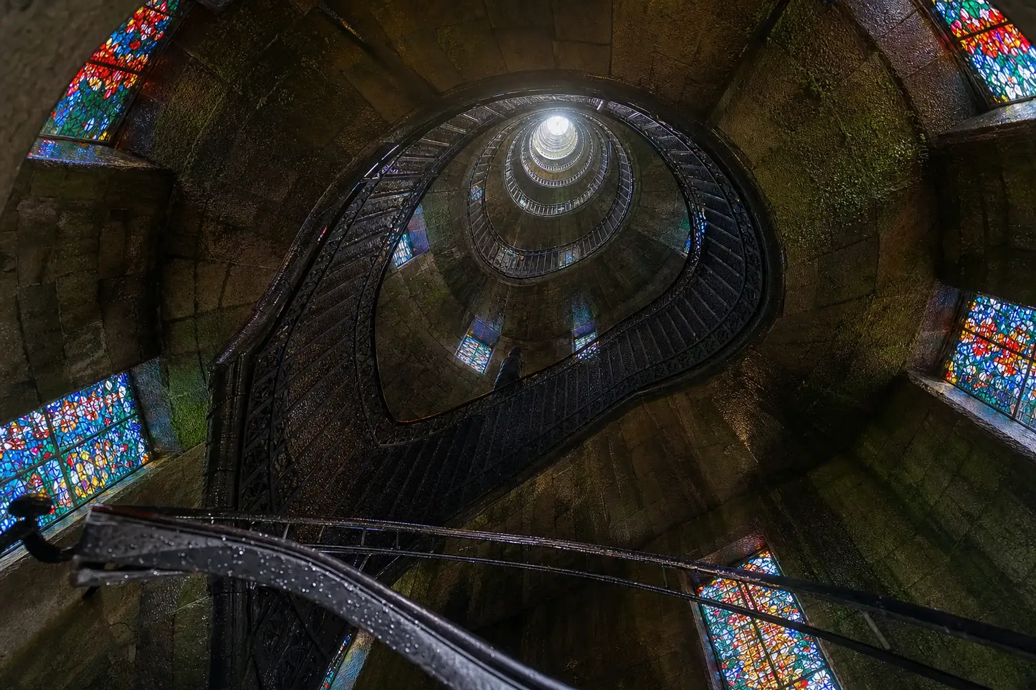 Gabriel Loire's 18-metre Symphonic Sculpture stained-glass tower at Hakone, colored light falling on the internal spiral staircase