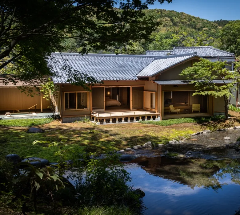 Asaba Ryokan in Shuzenji with lantern light reflecting on the central pond at dusk