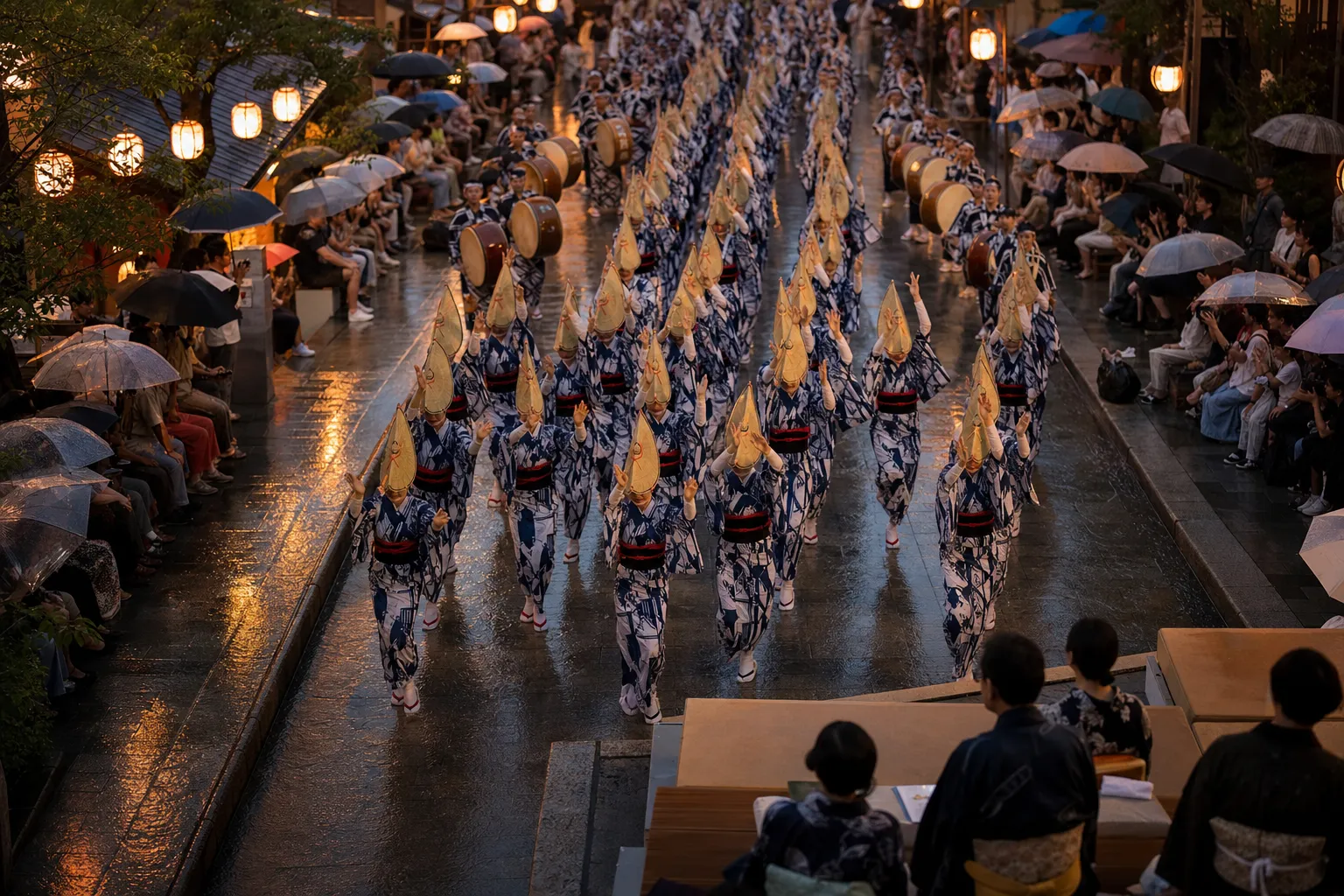 Awa Odori dancers in traditional dress performing on a crowded Tokushima street at night