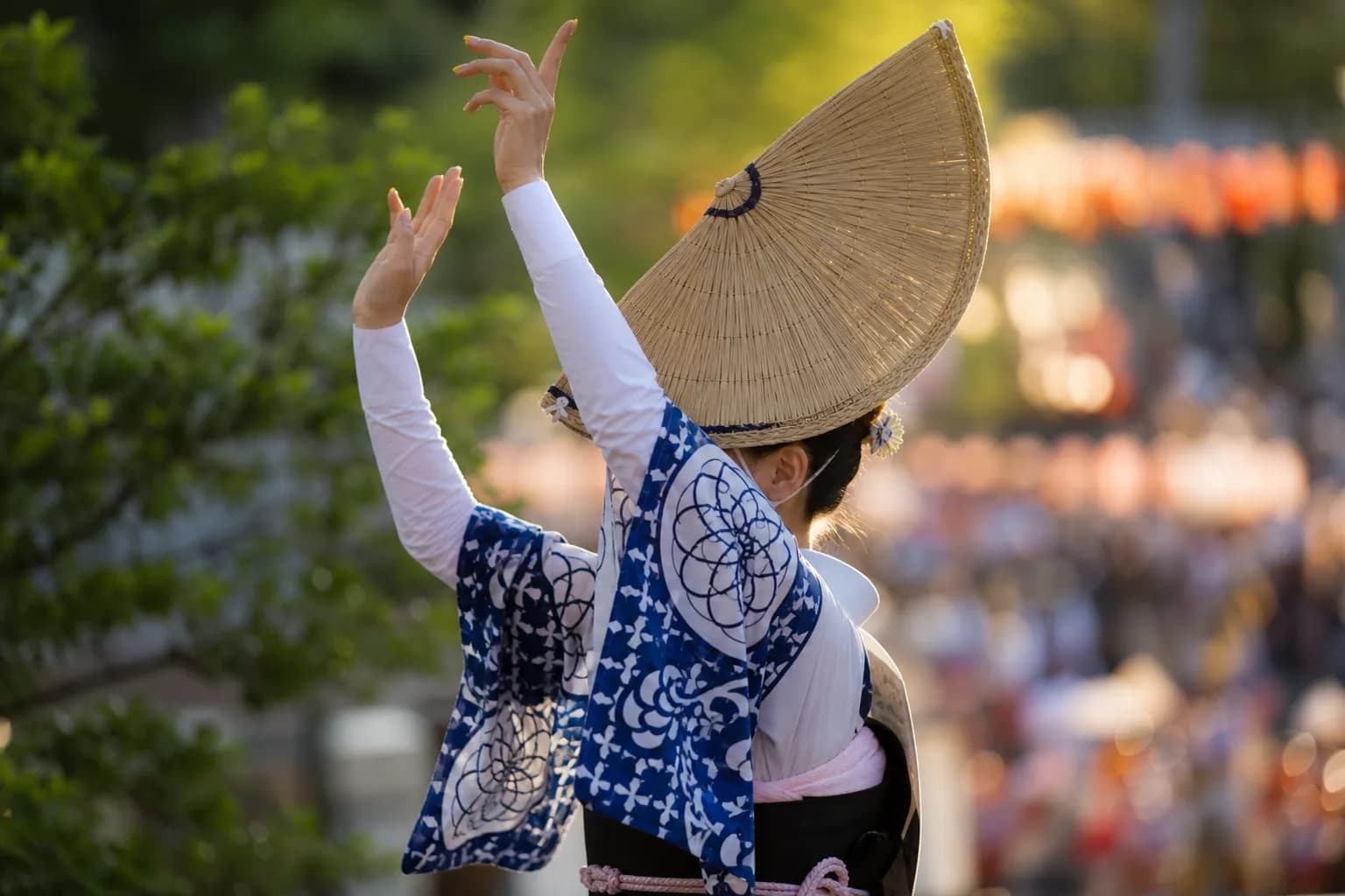 Female Awa Odori dancer in straw hat and yukata photographed from a clear reserved seat vantage