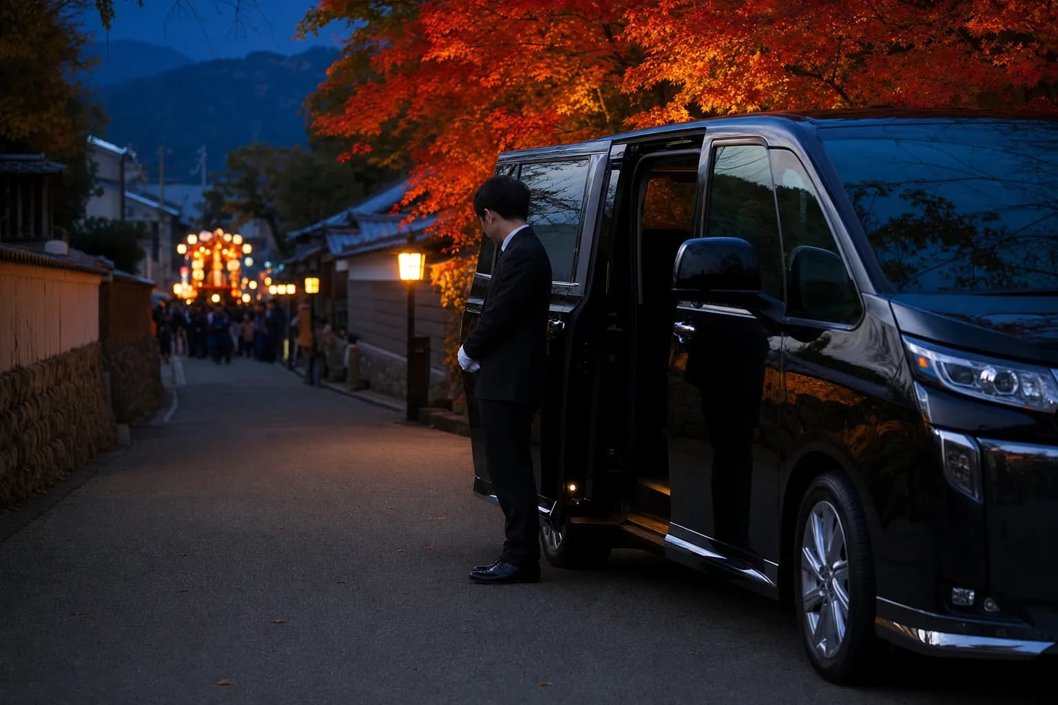Luxury chauffeured minivan waiting on a quiet Tokushima street during the Awa Odori festival at dusk