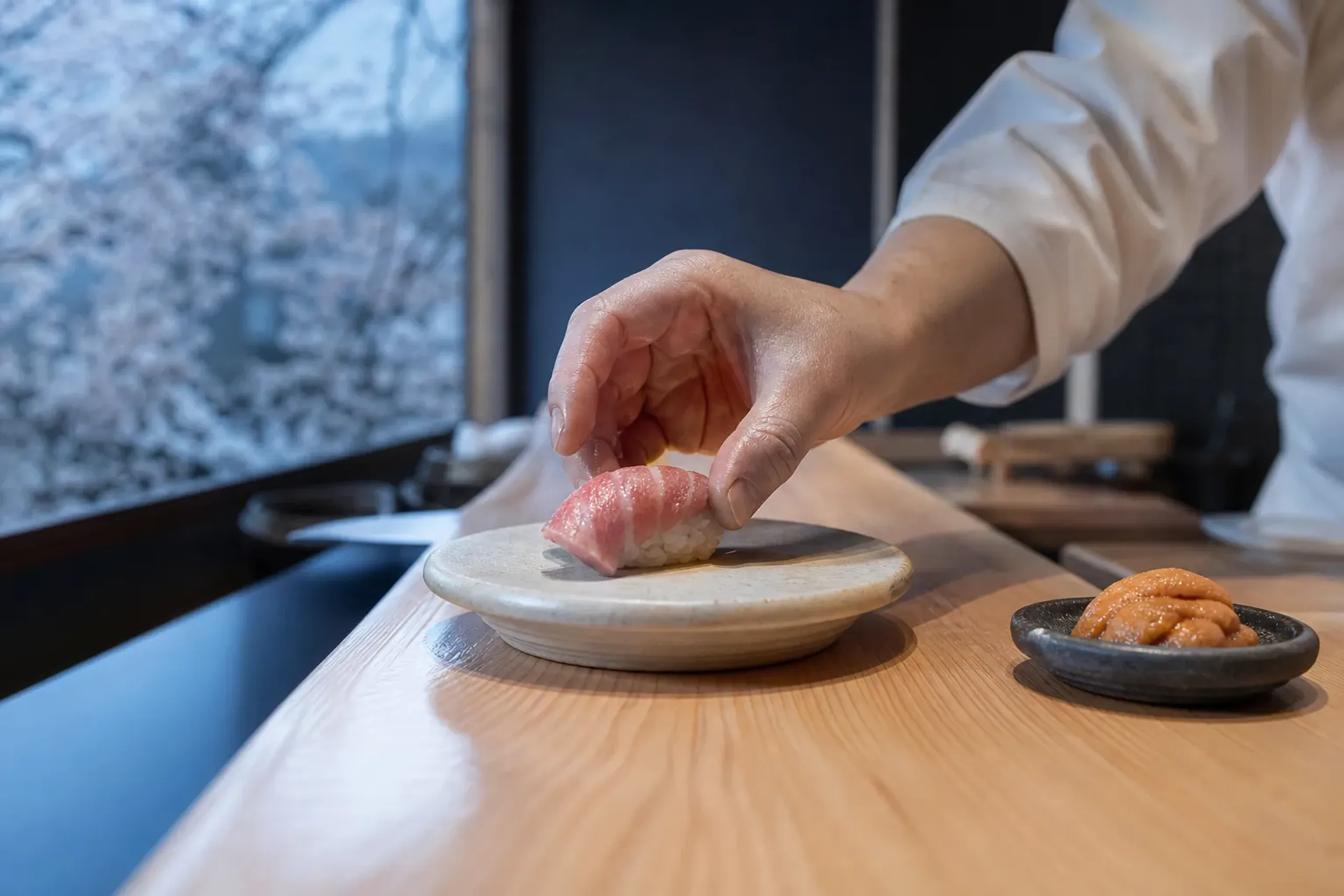 Otoro nigiri and uni served at a quiet sushi counter in Tokyo after an early Toyosu Market visit