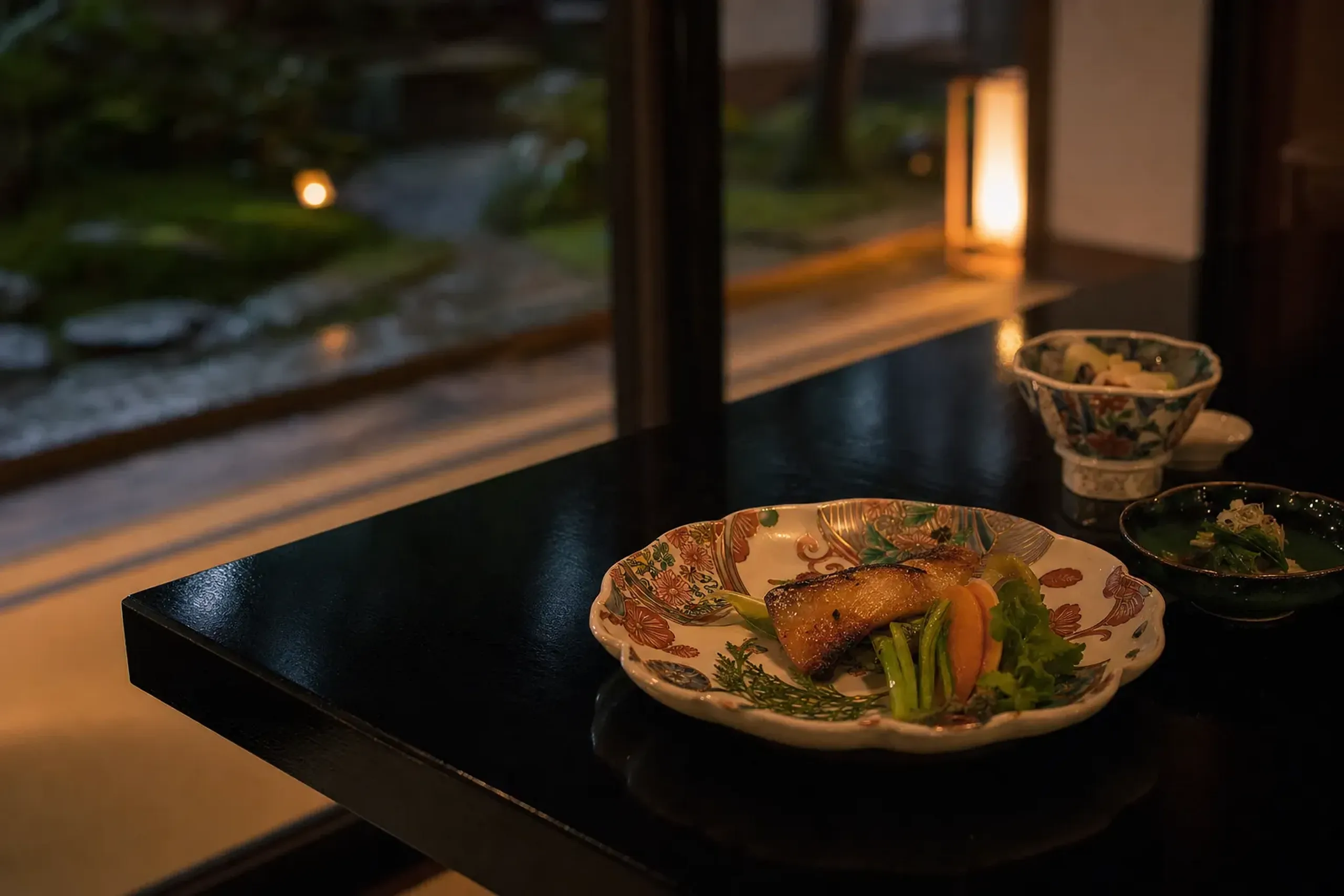 Multi-course kaiseki dinner plated on local Kutani ceramics at an onsen ryokan