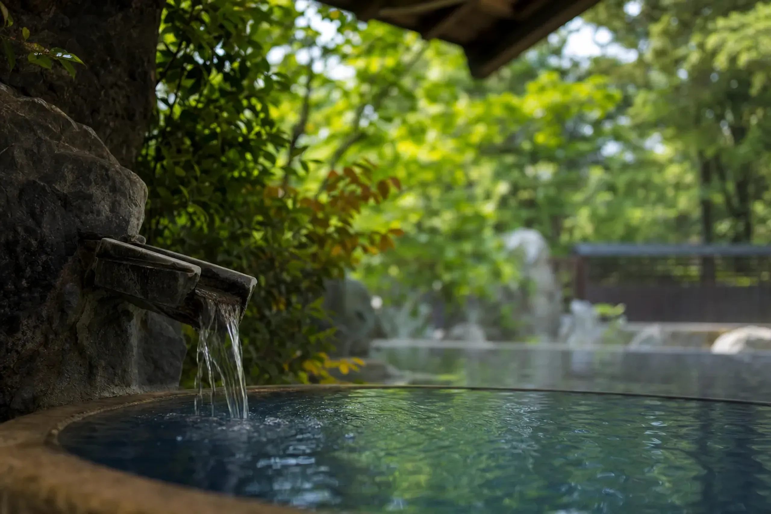 The cobalt blue boiling water of Umi Jigoku (Sea Hell) with rust-colored steam rising off its 98°C surface in Beppu's Kannawa district