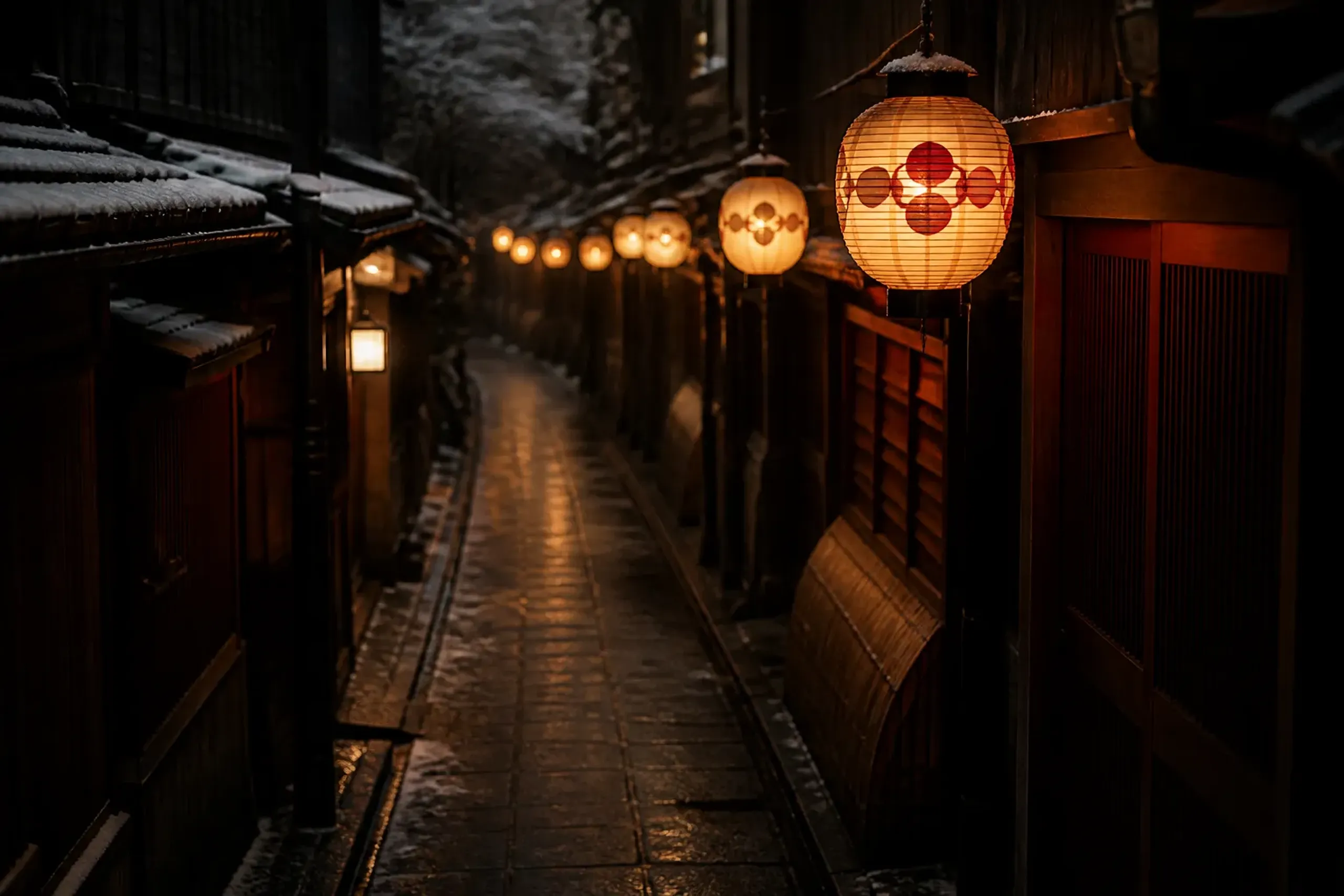 Paper lanterns in Kyoto at night suggesting festival season without showing crowds