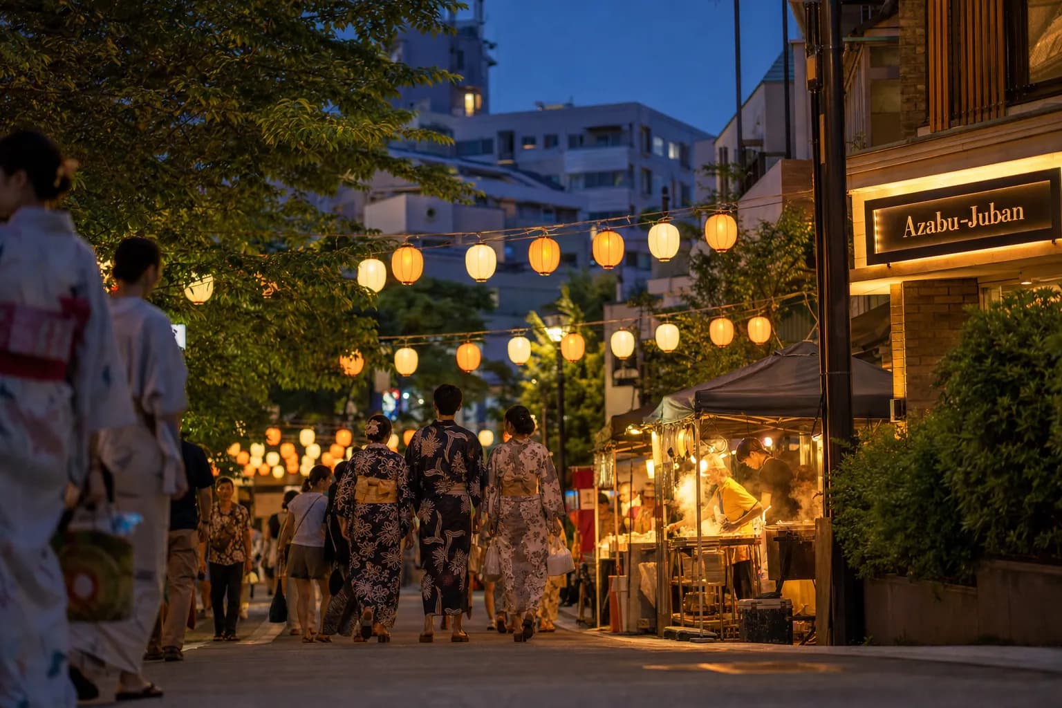 Lantern-lit Tokyo neighborhood festival street with summer yukata and food stalls