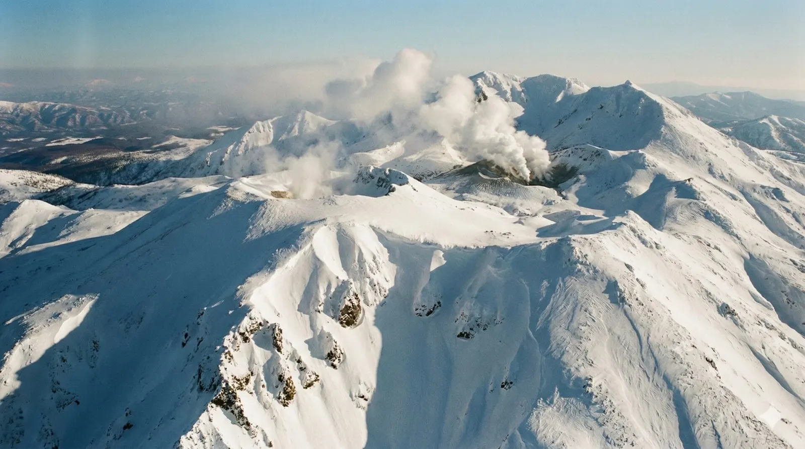 Aerial view of the snow-capped Daisetsuzan mountain range in Hokkaido, Japan.