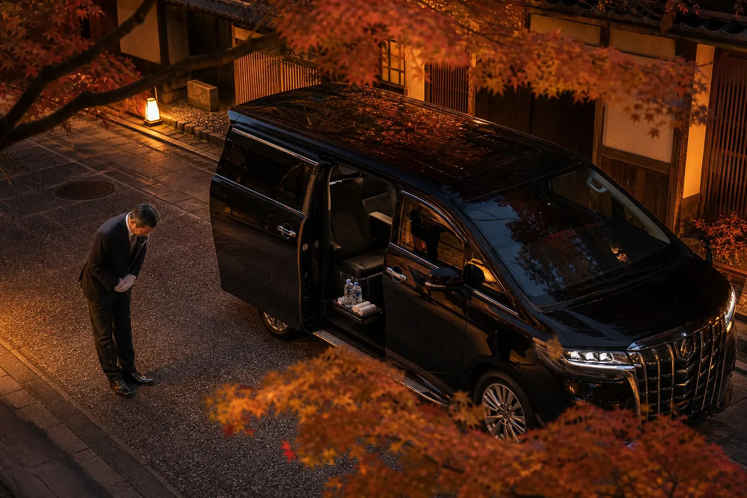 Luxury chauffeured minivan at curbside with the door open and amenities inside