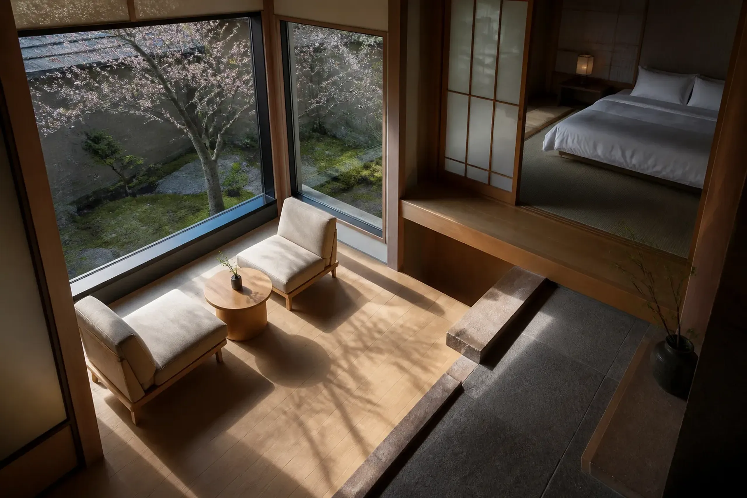 Corner guest room with seating area and window facing a quiet courtyard