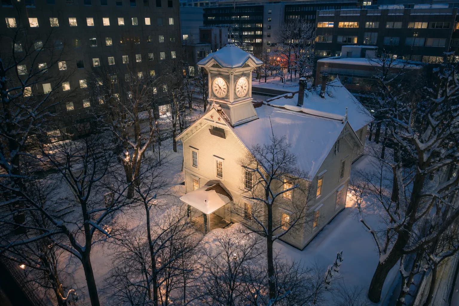Sapporo Clock Tower covered in winter snow against a grey sky