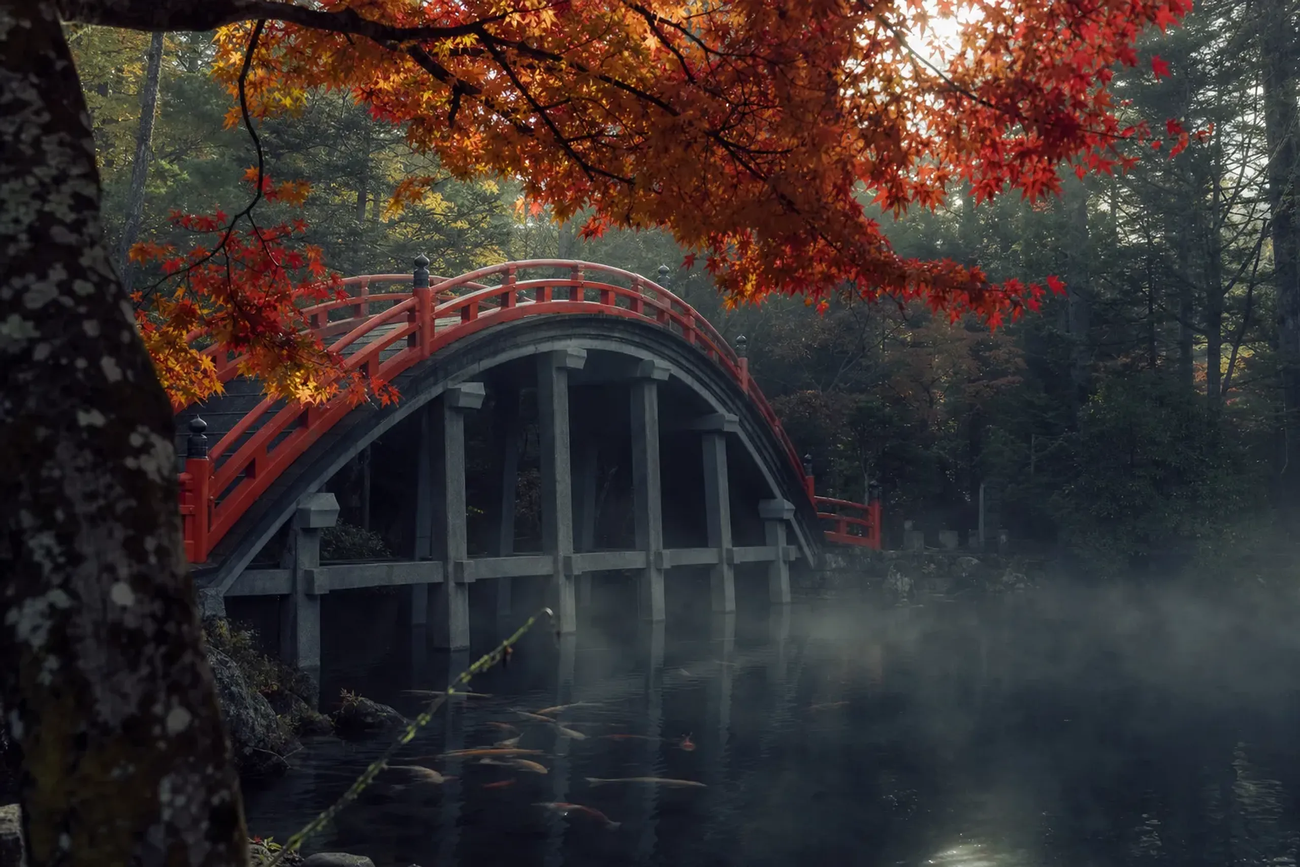 the arched vermilion Taiko-bashi drum bridge crossing the koi pond at Dazaifu Tenmangū