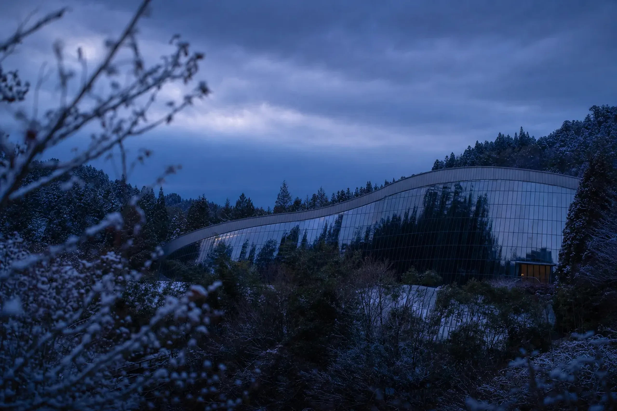the sweeping curved glass-and-steel exterior of the Kyushu National Museum near Dazaifu