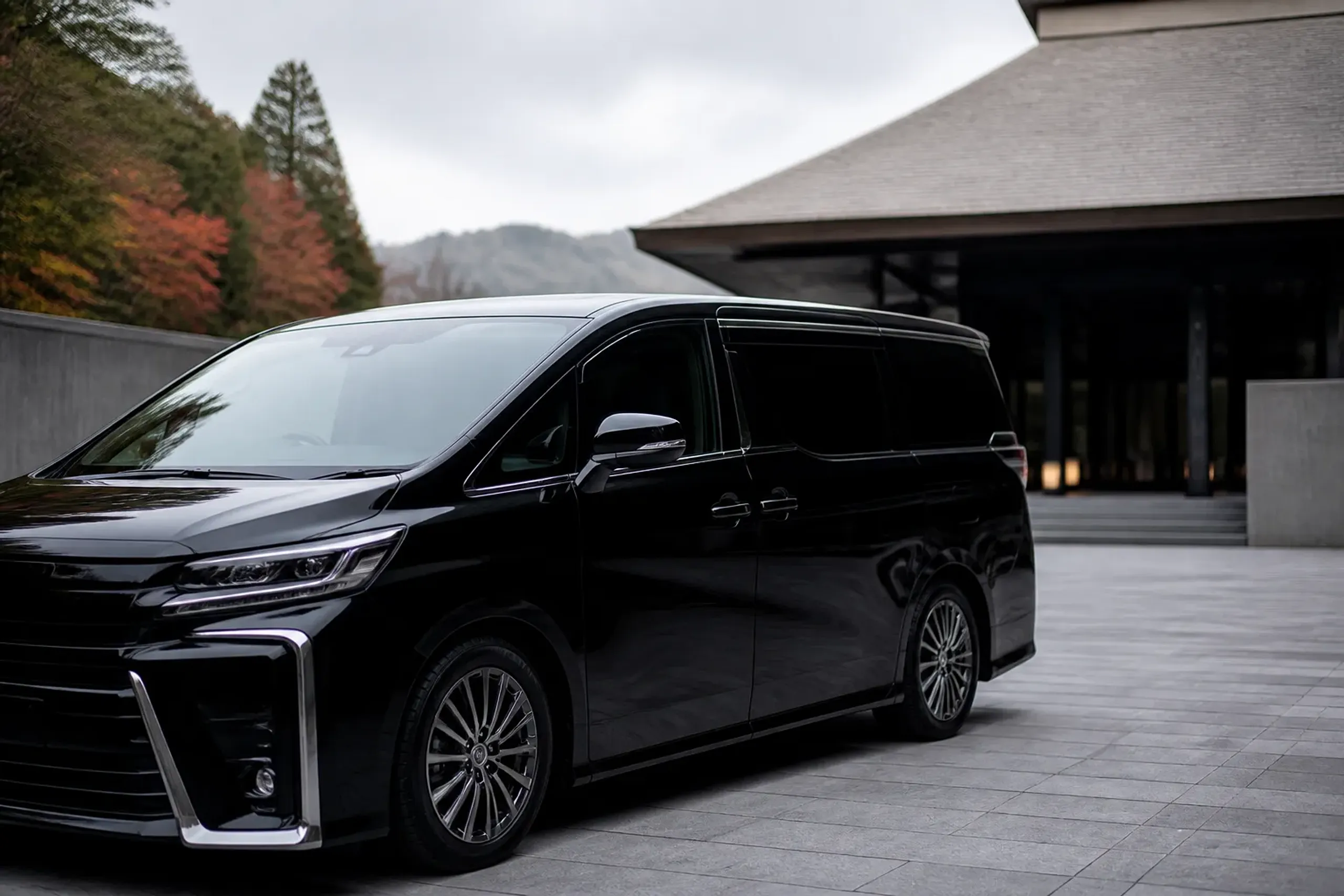 Luxury minivan with tinted windows at a hotel driveway in Japan for discreet transfers