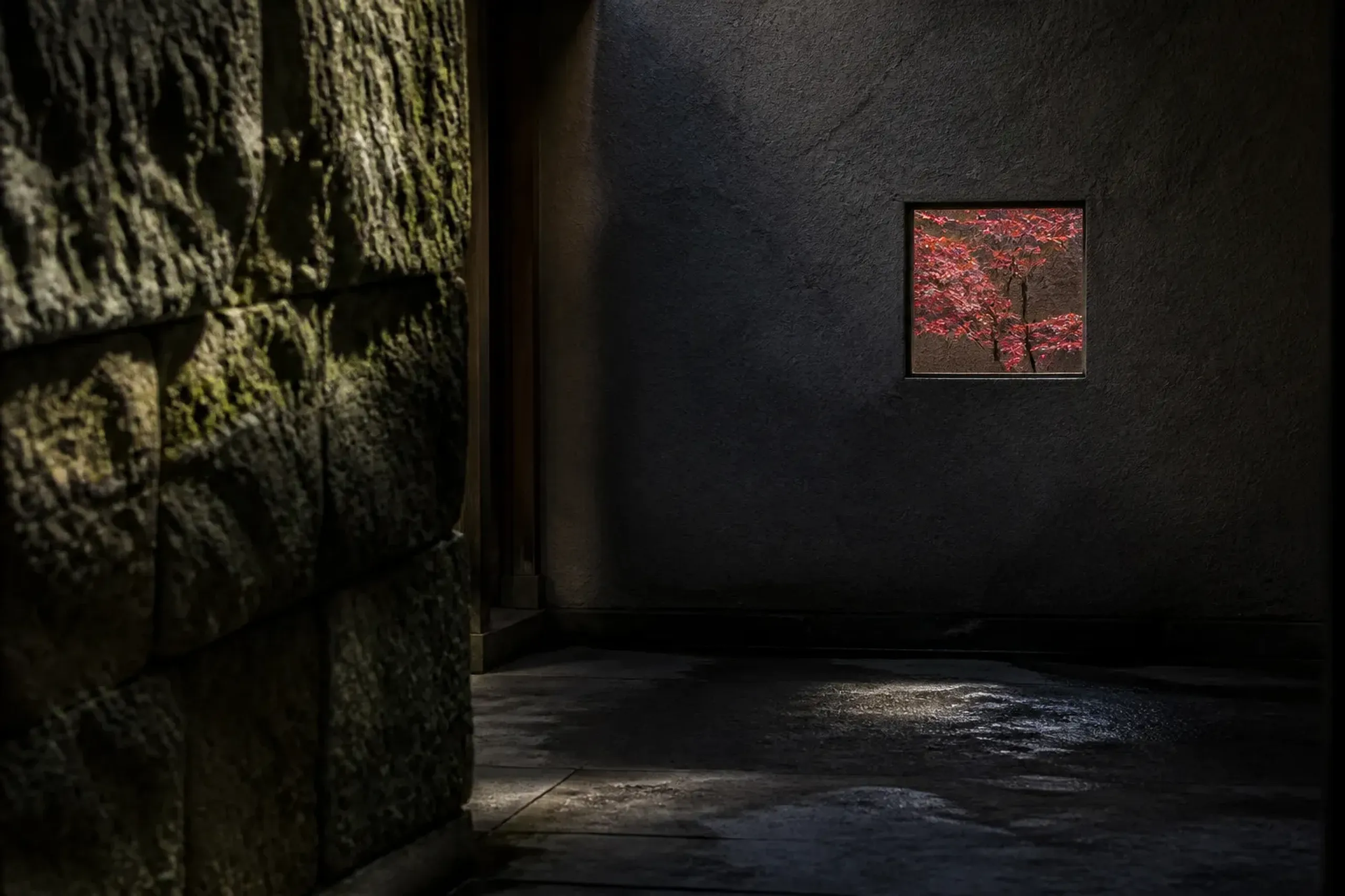a concealed secondary ryokan entrance of unpolished stone and moss, a vestibule wall forcing a turn to break the sightline from the street, with a single small window framing a red maple branch