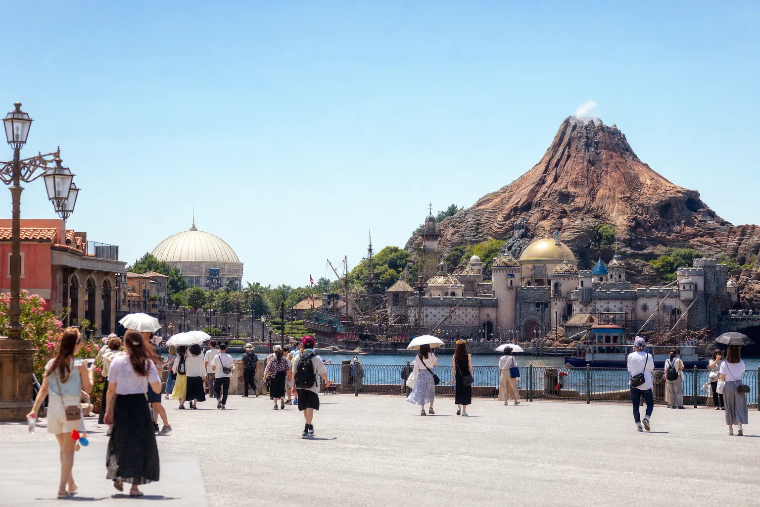 Vibrant theme park scene with a crowd near a volcano and dome during the day. — Photo by Yan - on Pexels