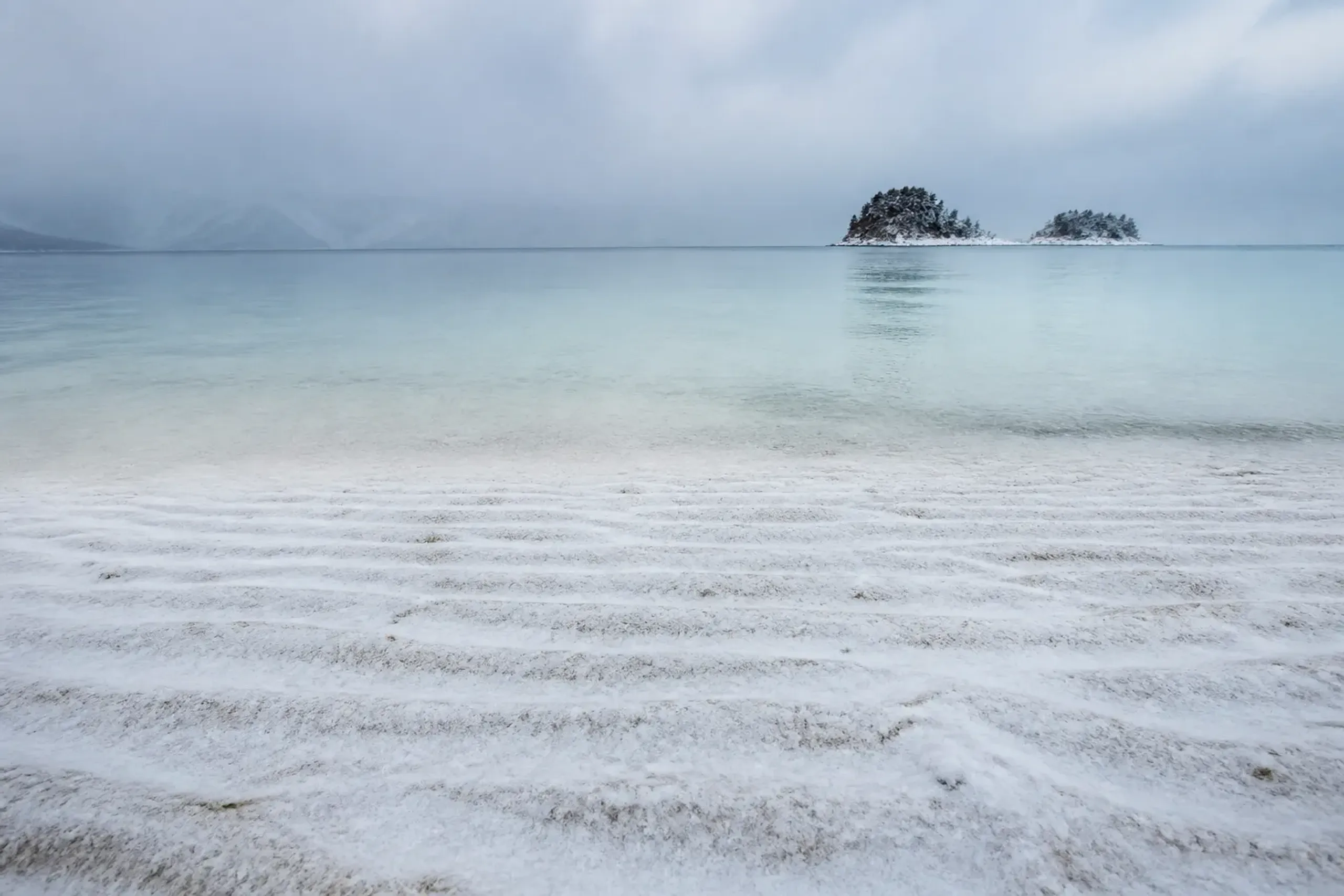 Deserted white-sand beach with turquoise shallows on Aka Island, Kerama