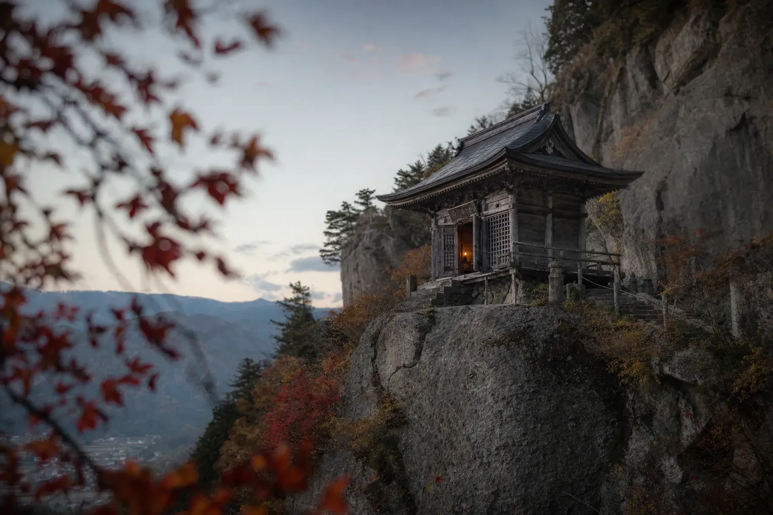 the weathered wooden main hall of Yamadera (Risshaku-ji) in Yamagata, perched on its northern mountainside, where the divided flame was kept and carried back 700km to Mount Hiei
