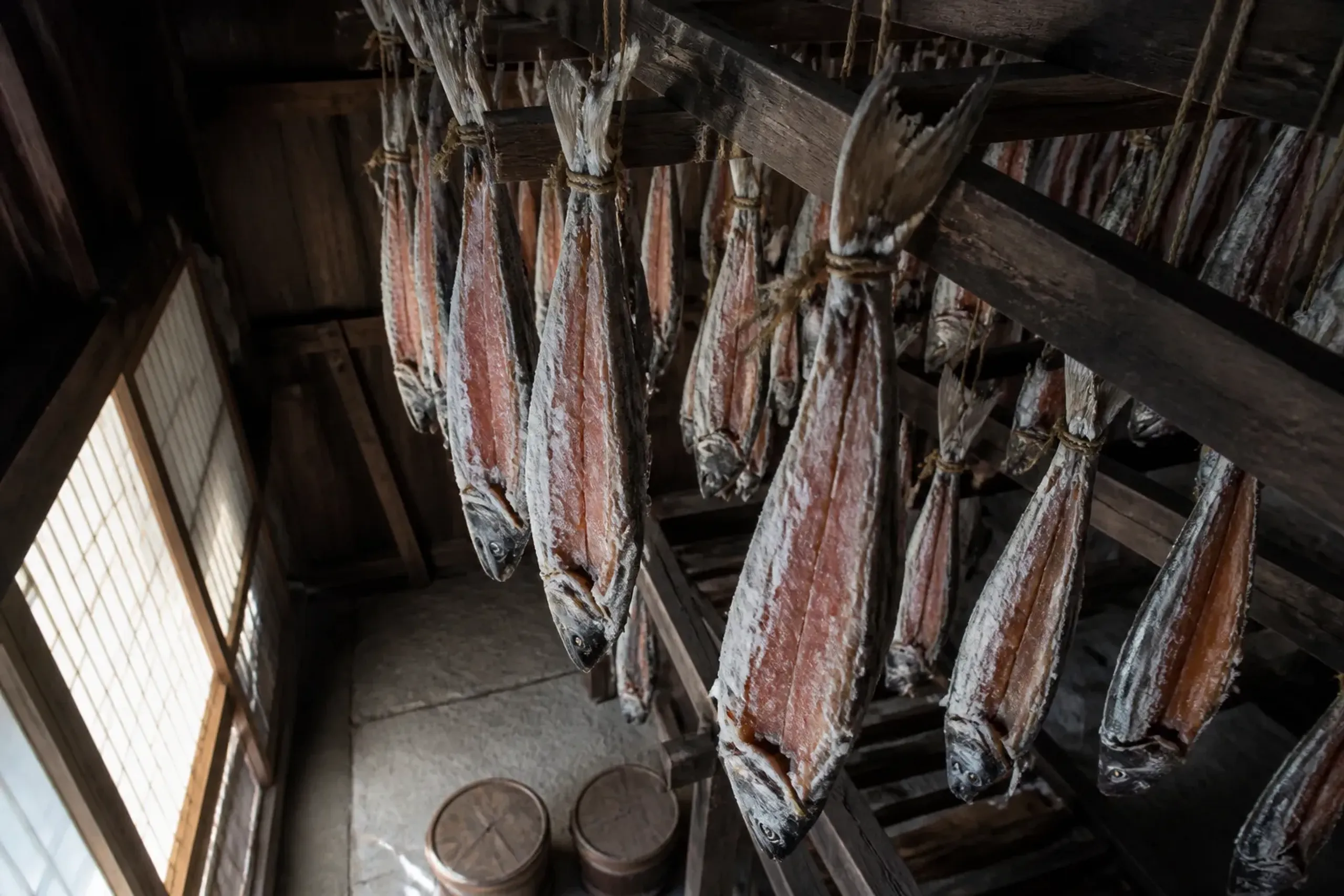 Traditional salted salmon air-drying under the eaves of a Murakami merchant house