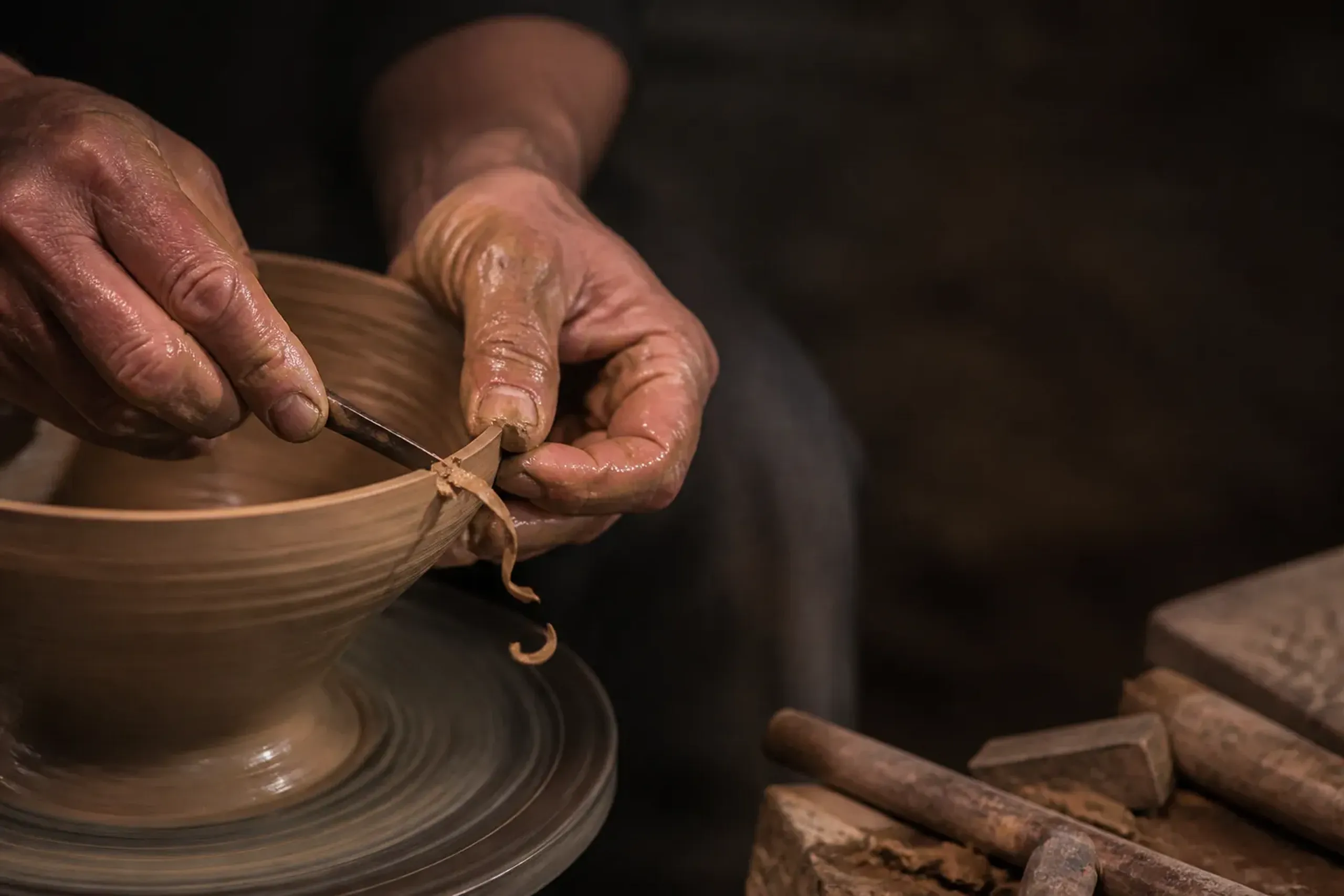 Close-up of artisan hands working with traditional tools in a Japanese workshop
