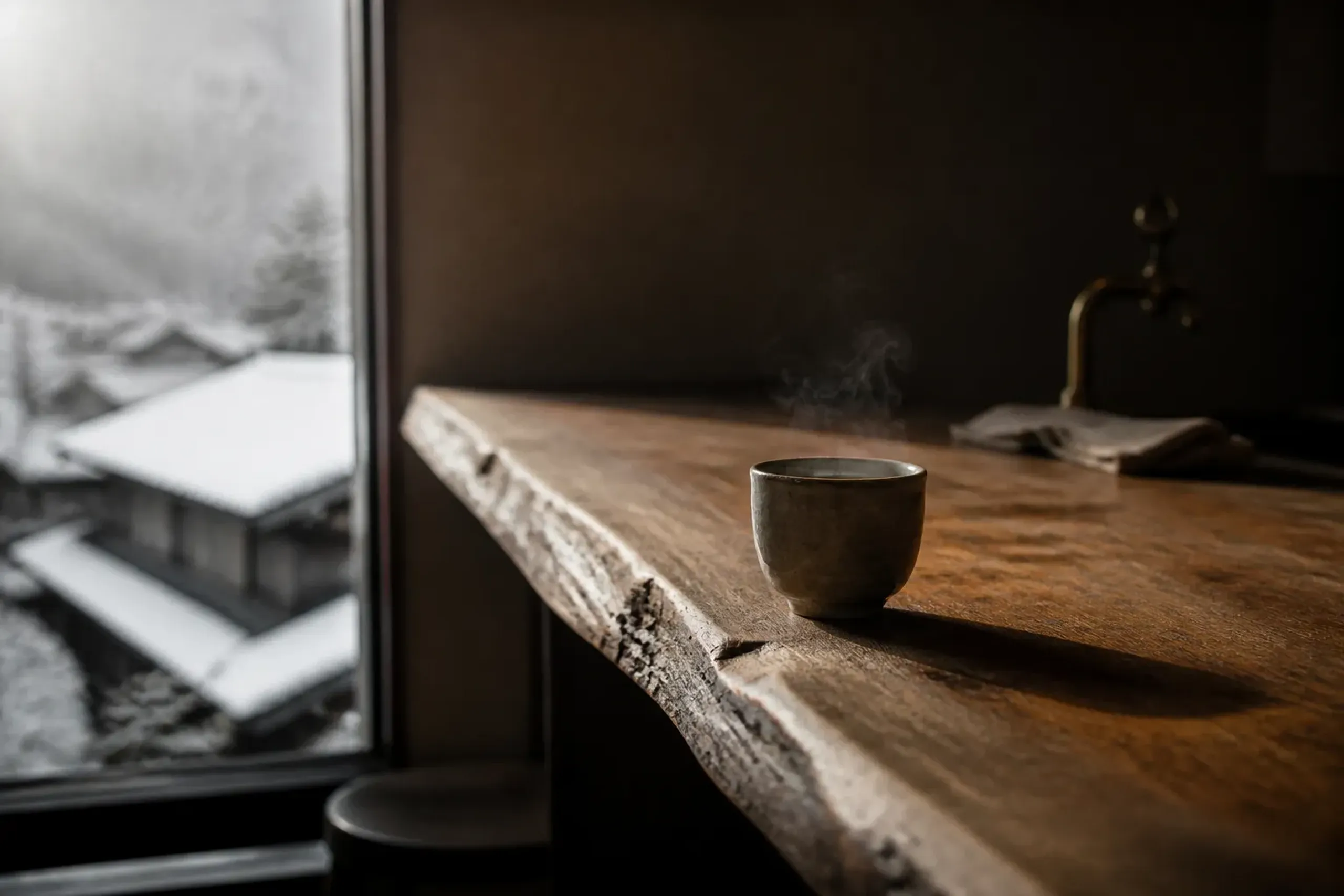 a quiet Tokyo neighbourhood coffee house counter with a single pour-over cup on a wooden bar, morning light through the window