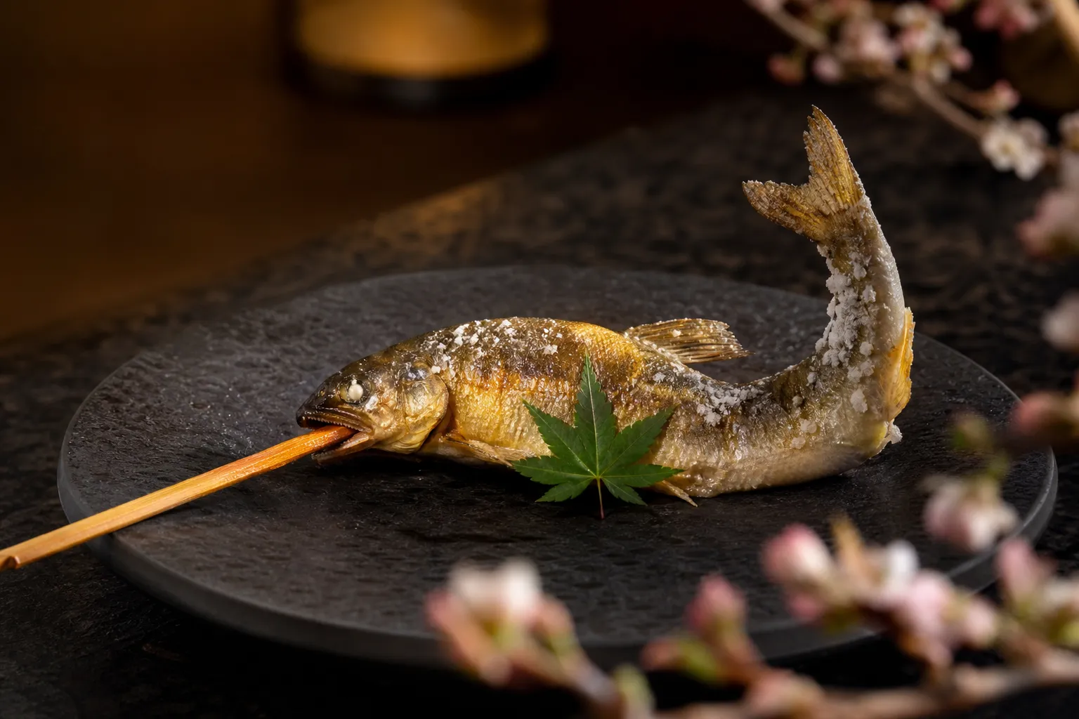 Whole salt-grilled ayu sweetfish skewered and plated in traditional shioyaki style