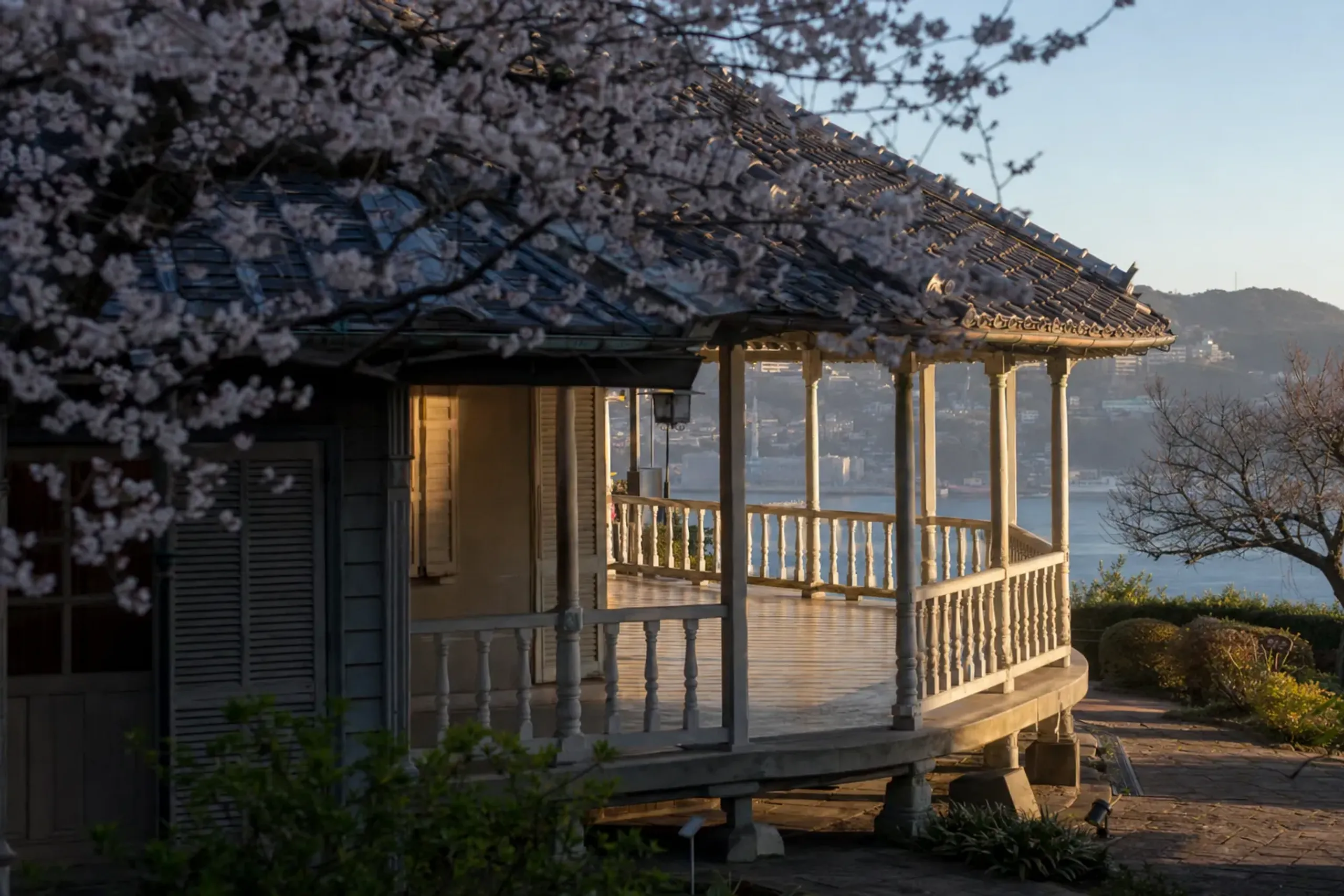 The verandas and tiled roof of the Former Glover House, showing the bungalow proportions and East-West wooden craftsmanship, overlooking Nagasaki harbor