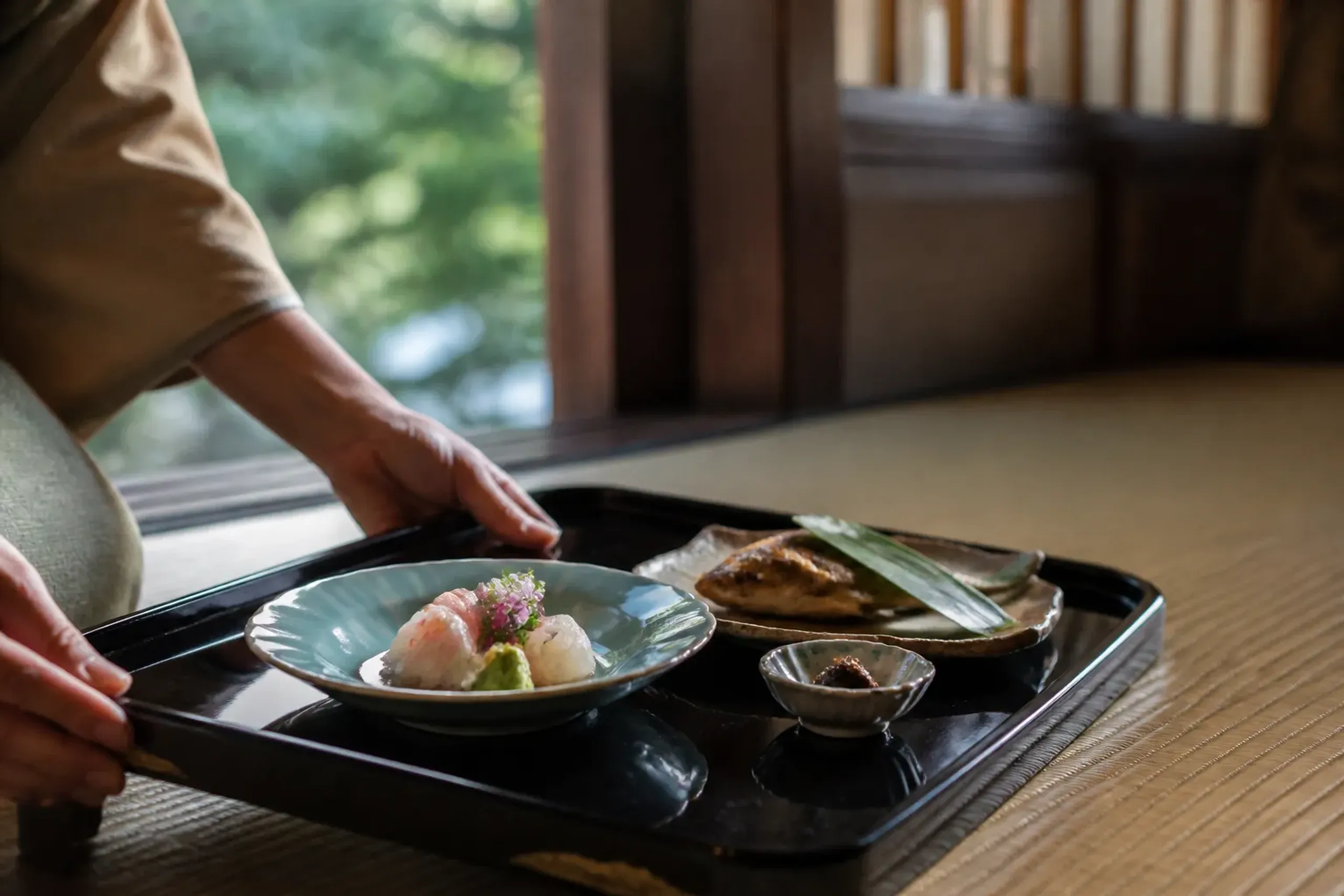 Multi-course seasonal kaiseki dinner plated on ceramic and lacquer at a Hakone ryokan