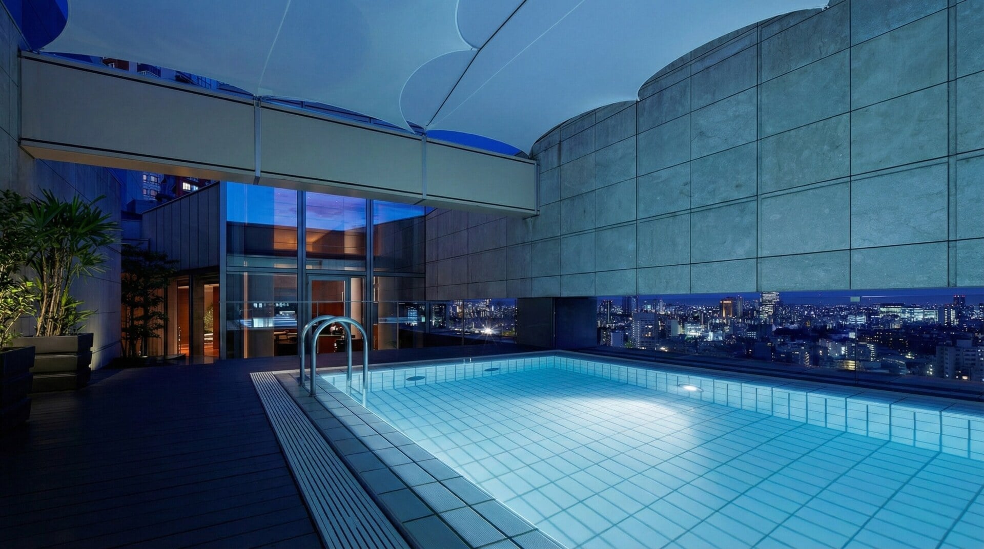 Private heated outdoor pool at the Grand Hyatt Tokyo Presidential Suite at night.