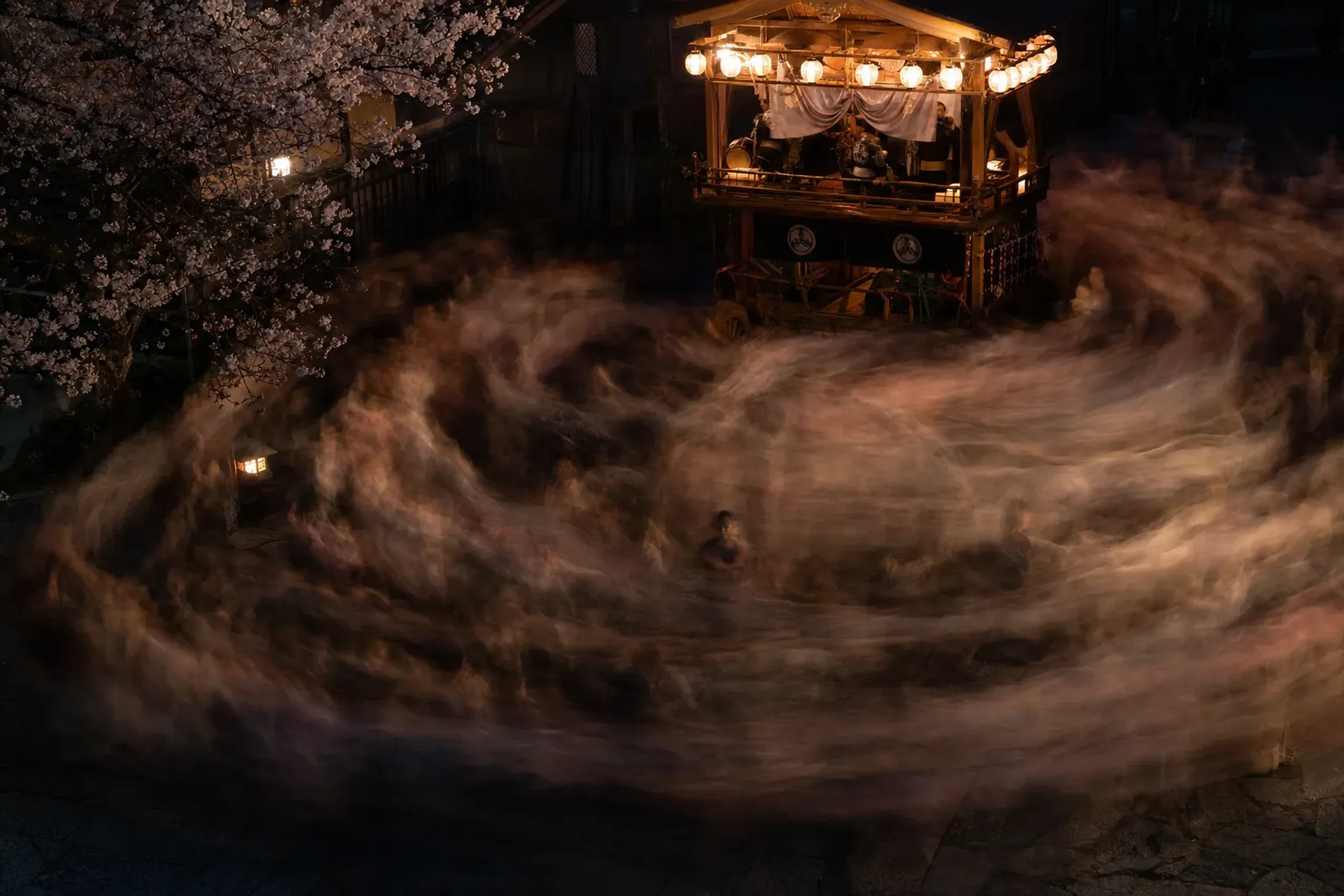 A moving current of dancers crossing and circling before the stage cart as the final Matsusaka dance plays