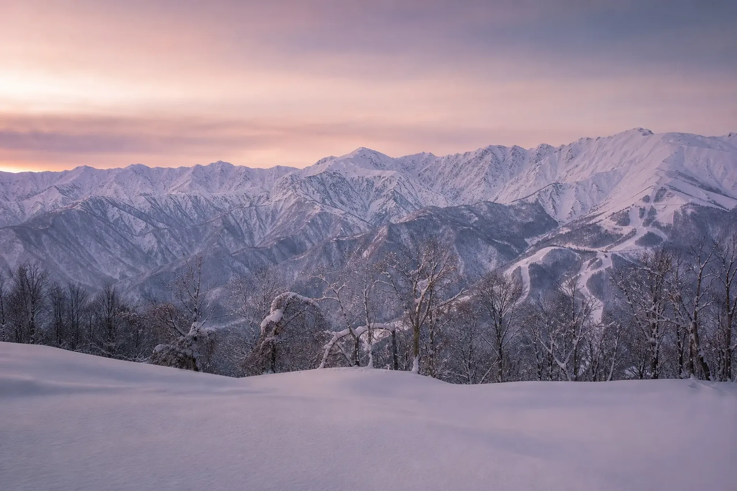 Snow-covered ridgelines of Hakuba Valley in the Japan Alps on a clear winter morning