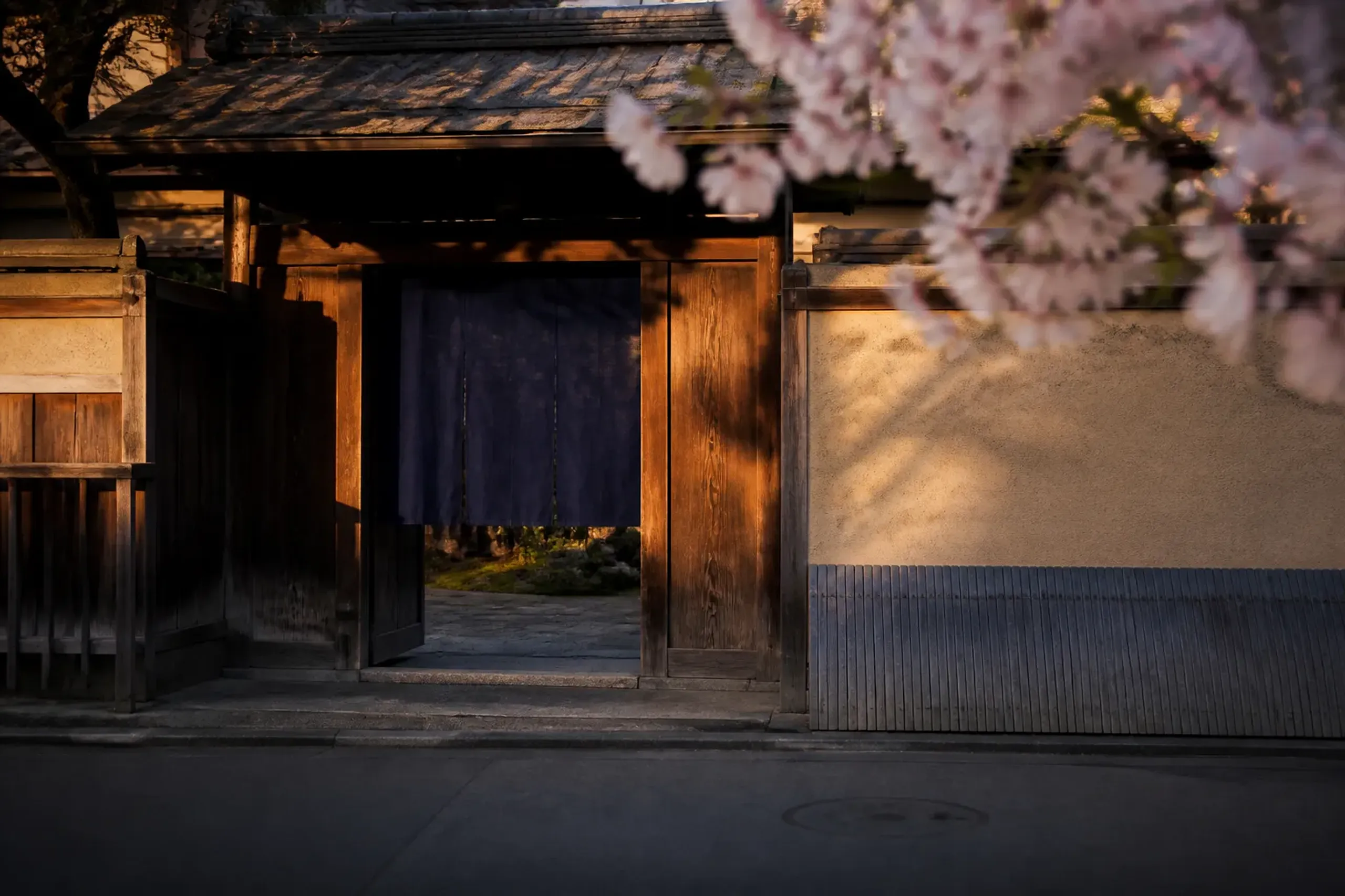 Traditional wooden entrance of a Kyoto ryokan on a calm street in Nakagyo Ward