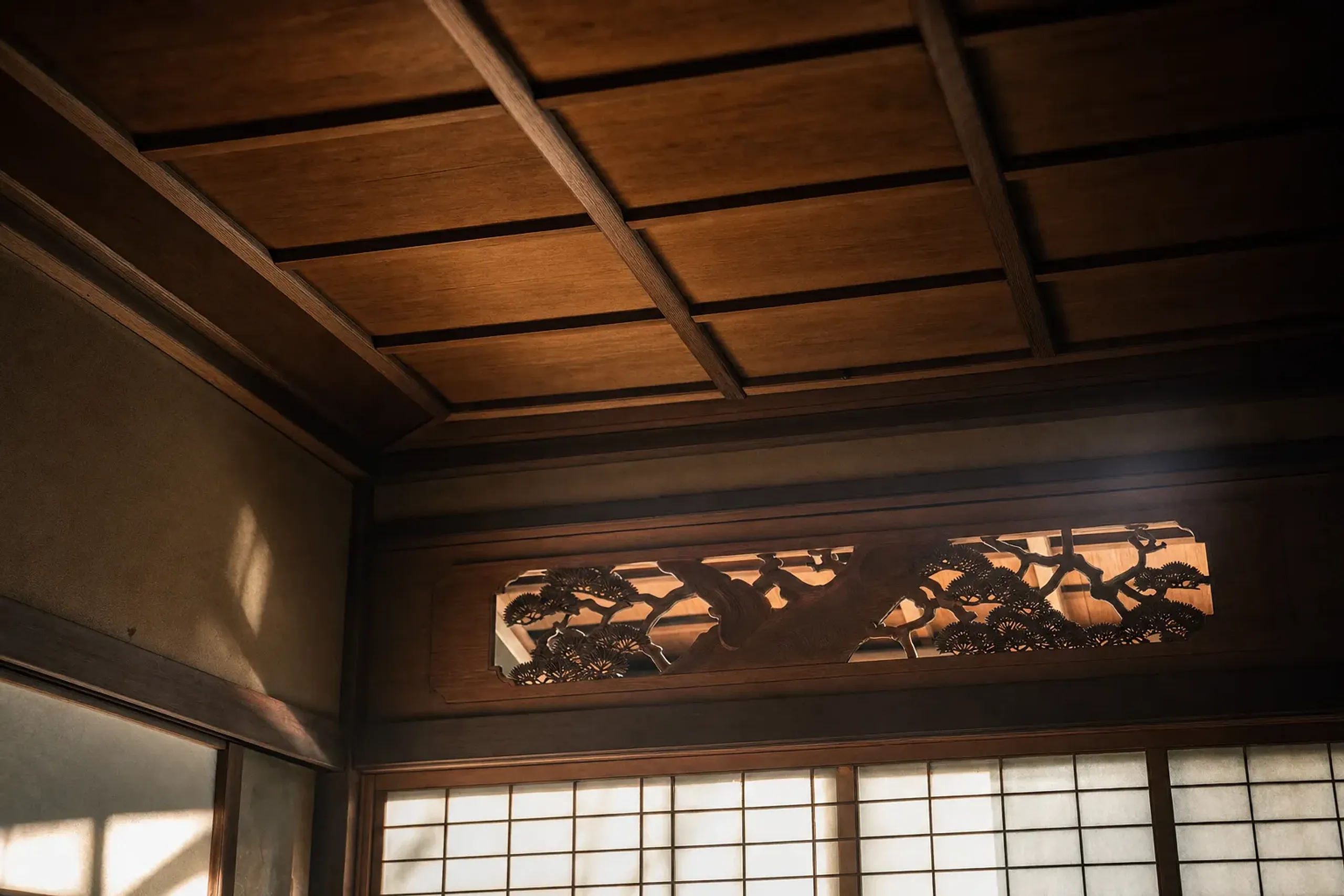 the hand-finished Meiji-era ceiling work and carved transoms inside HOSHINOYA Kyoto's 1897 ryokan building, showing shokunin craftsmanship