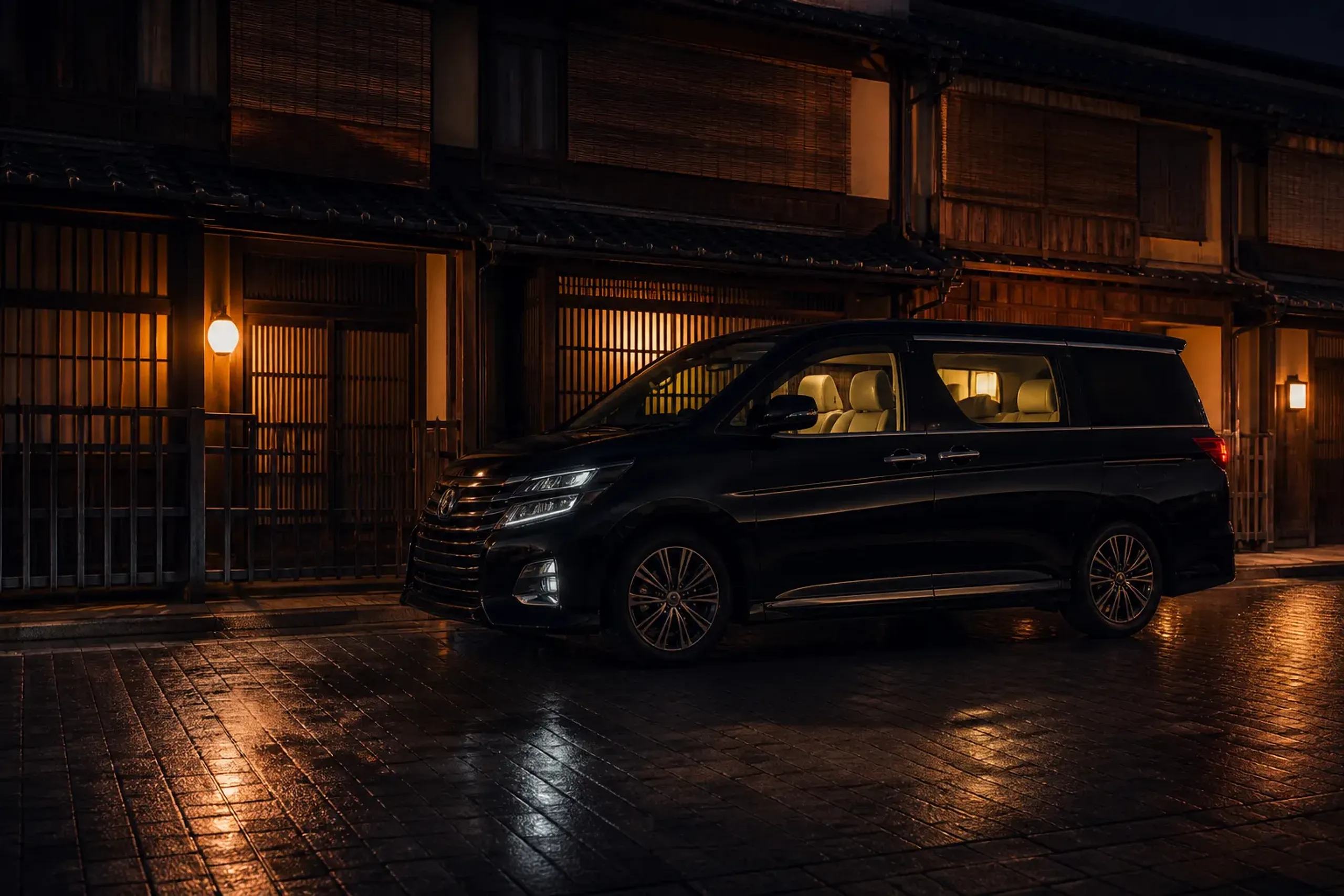 Black luxury minivan staged on a quiet Kyoto street at night for private chauffeur routing