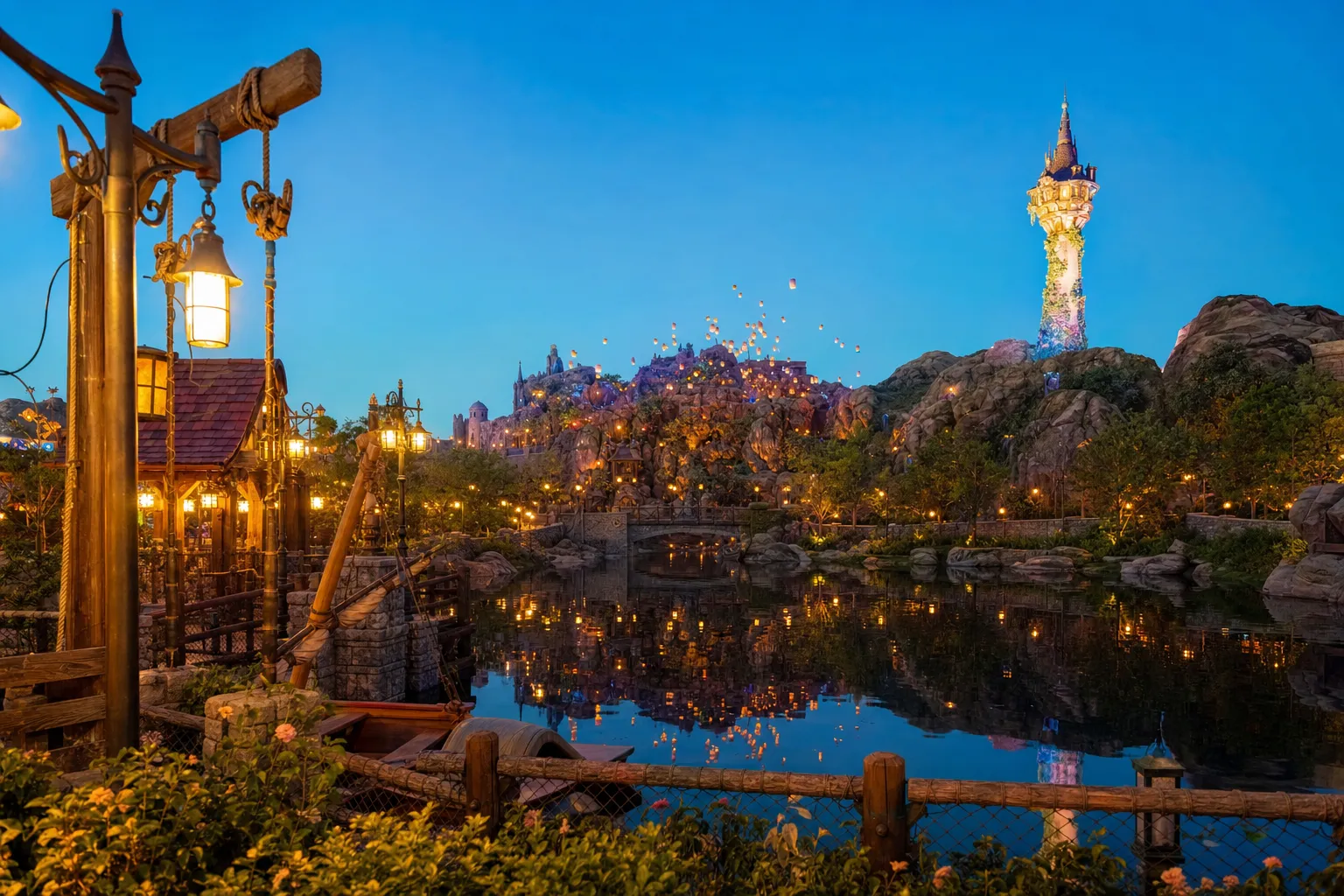 Fantasy Springs themed port at Tokyo DisneySea glowing at dusk with lantern lights and water reflections