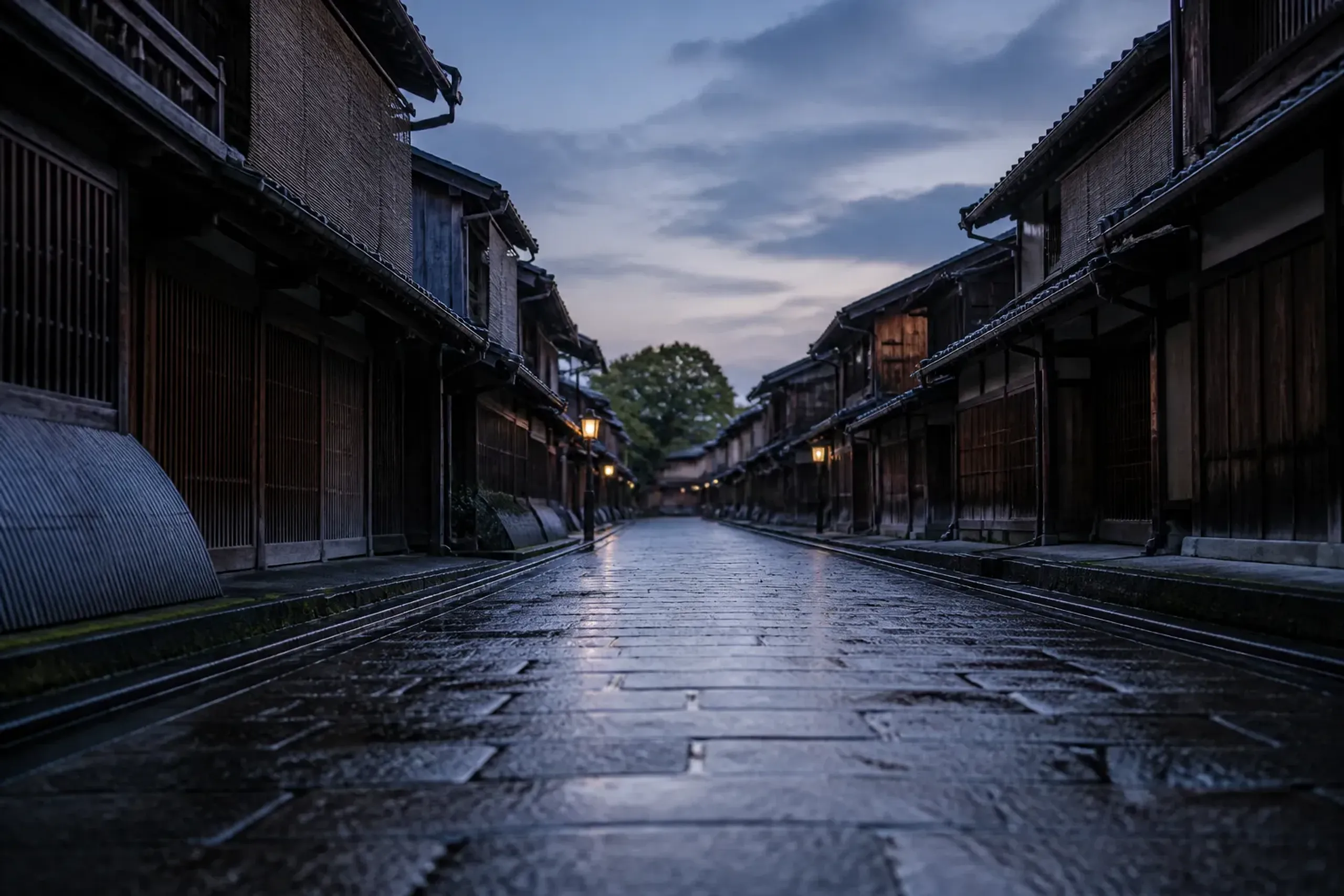 Empty stone-paved Kyoto lane at dawn with traditional wooden facades, illustrating discreet travel timing