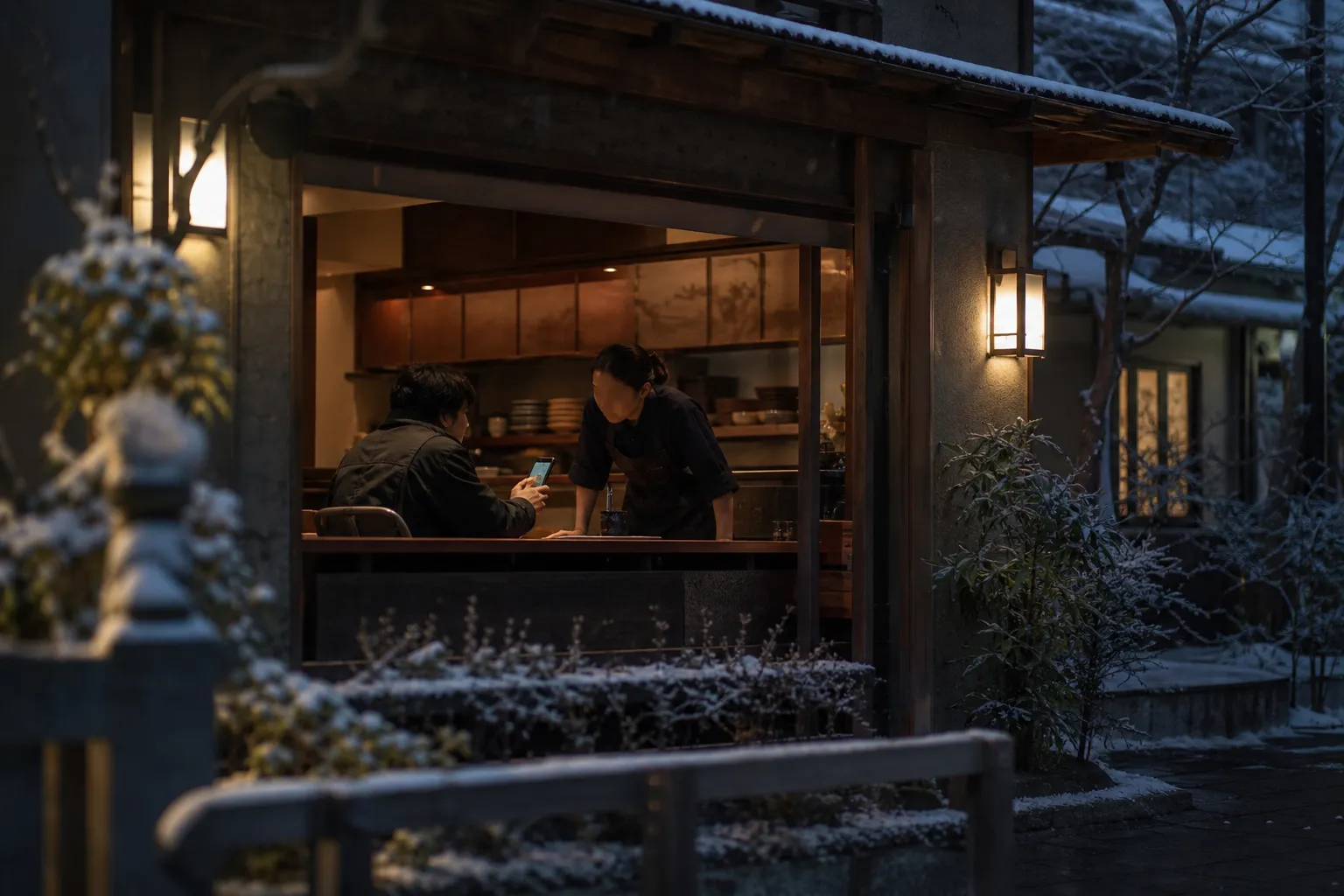 Traveler showing written Japanese dietary questions on a phone to a restaurant server in Kyoto