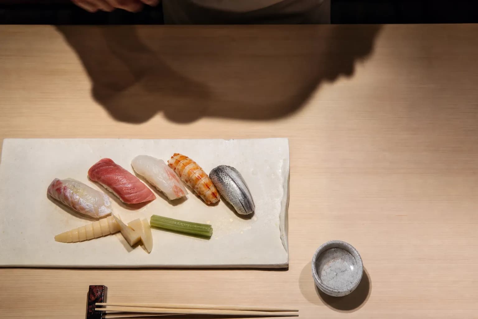An exquisitely arranged platter of seasonal sushi and spring vegetables served in a high-end Osaka restaurant.