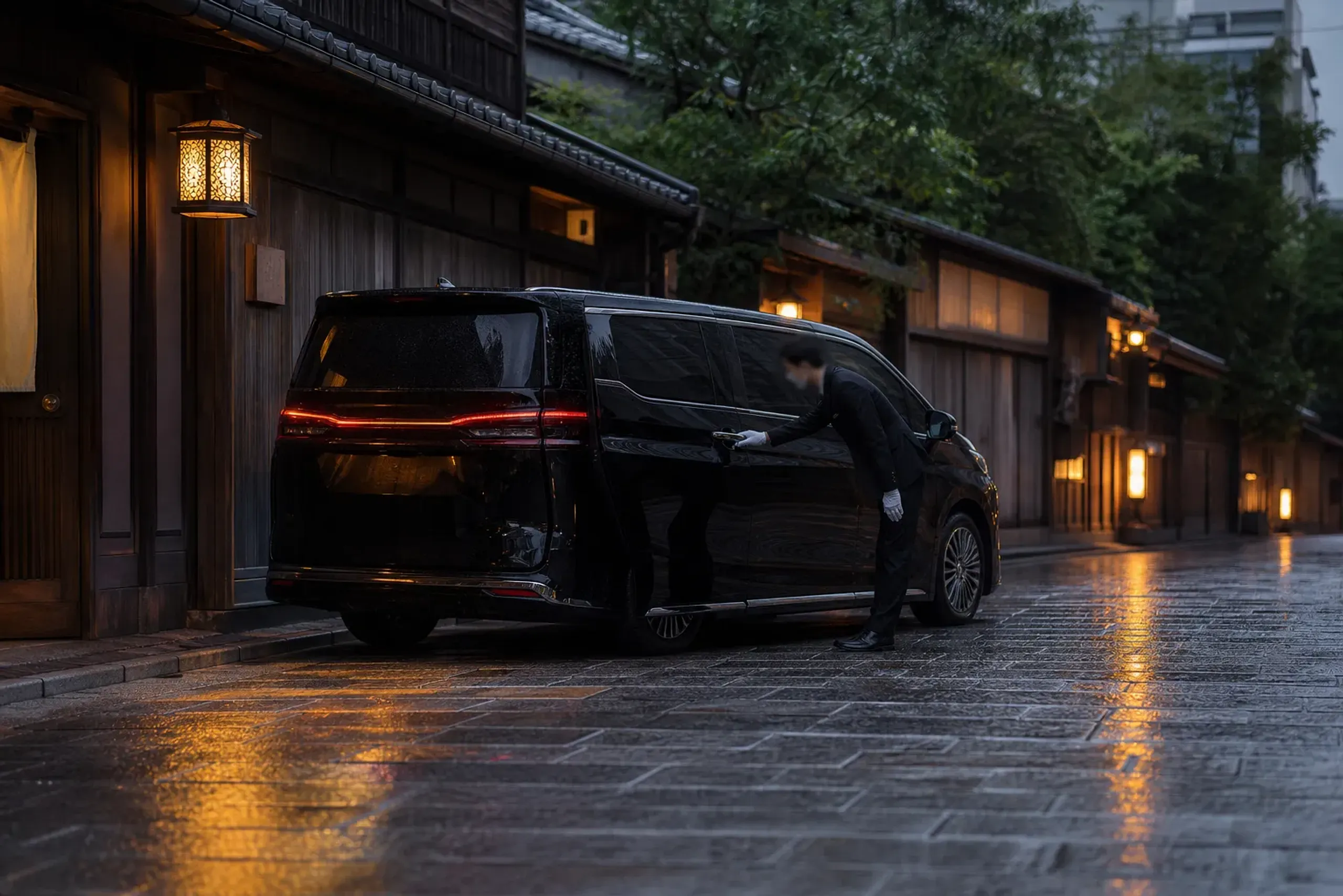 Black Lexus LM 500 luxury minivan with chauffeur on a quiet Kyoto street