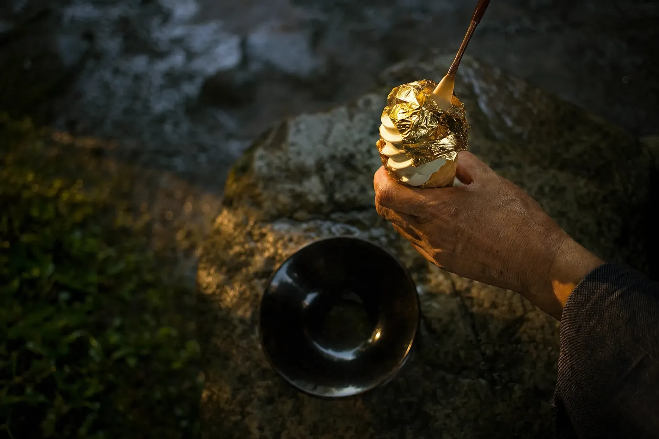 a lacquerware bowl and soft-serve ice cream cone wrapped in shimmering Kanazawa gold leaf