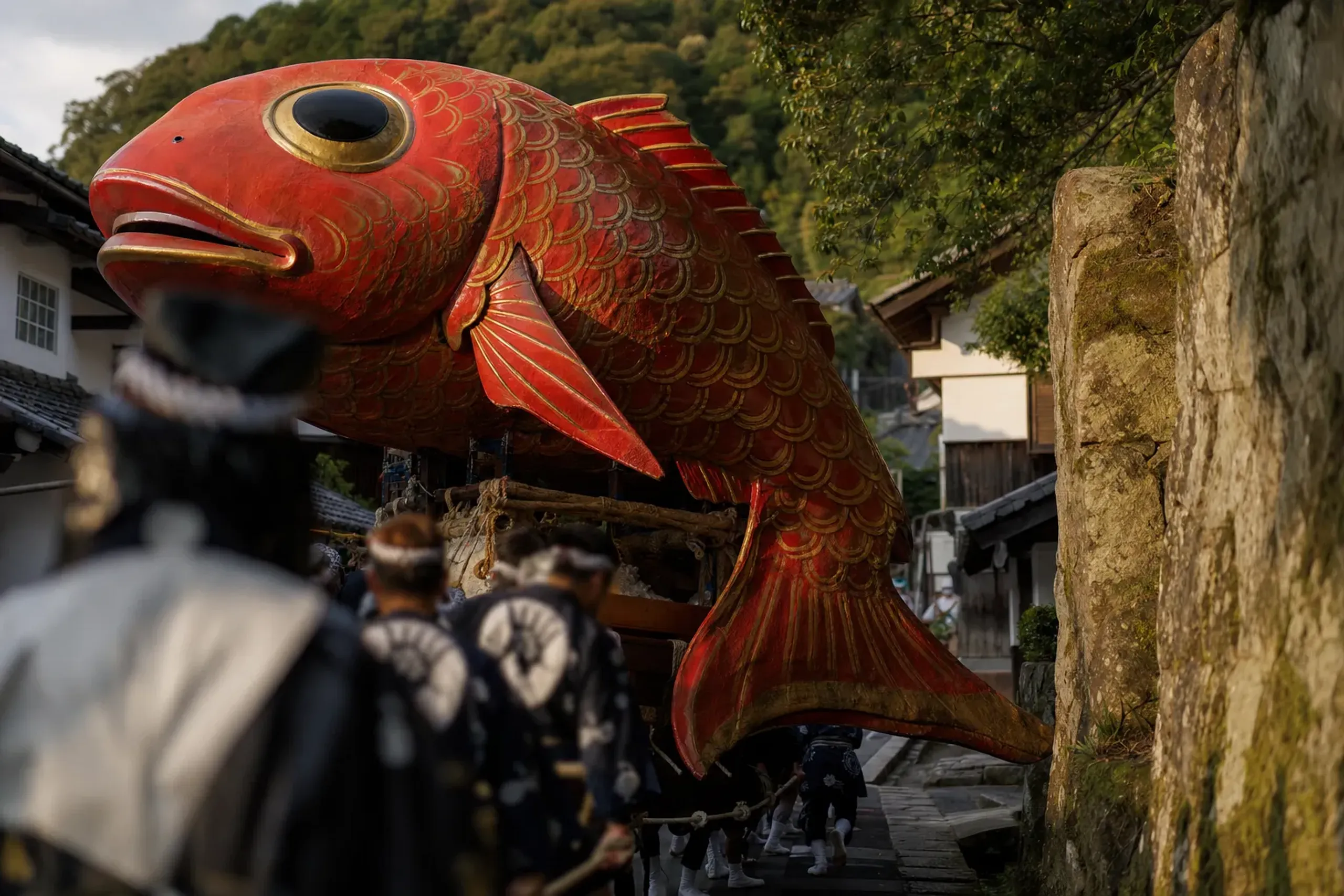 Karatsu Kunchi's 1845 Sea Bream (tai) hikiyama float with its deliberately exaggerated eyes and oversized fins, its articulated fins mid-movement, red and gold lacquer surface gleaming