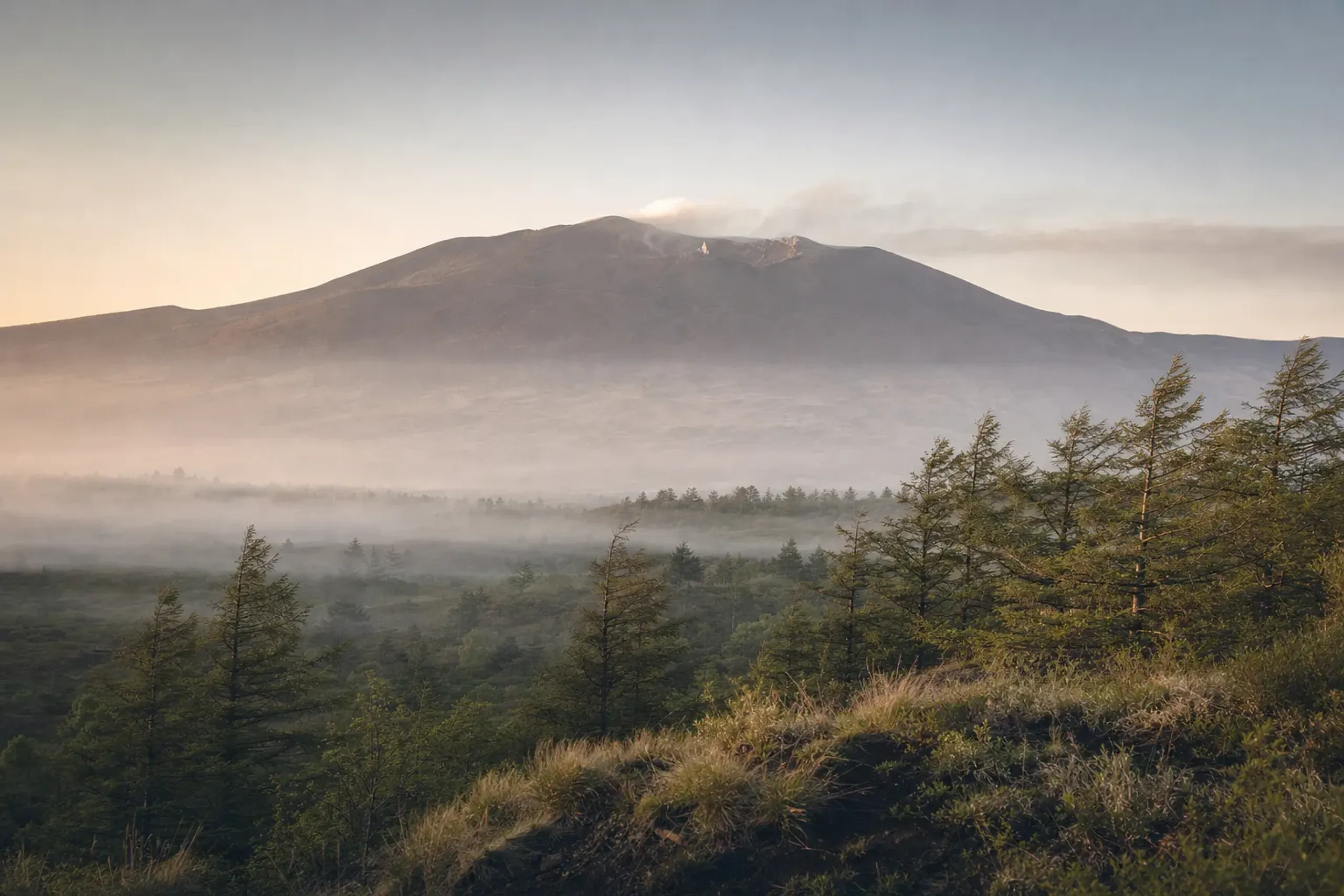 the smoking summit of active volcano Mount Asama rising above the Karuizawa highlands