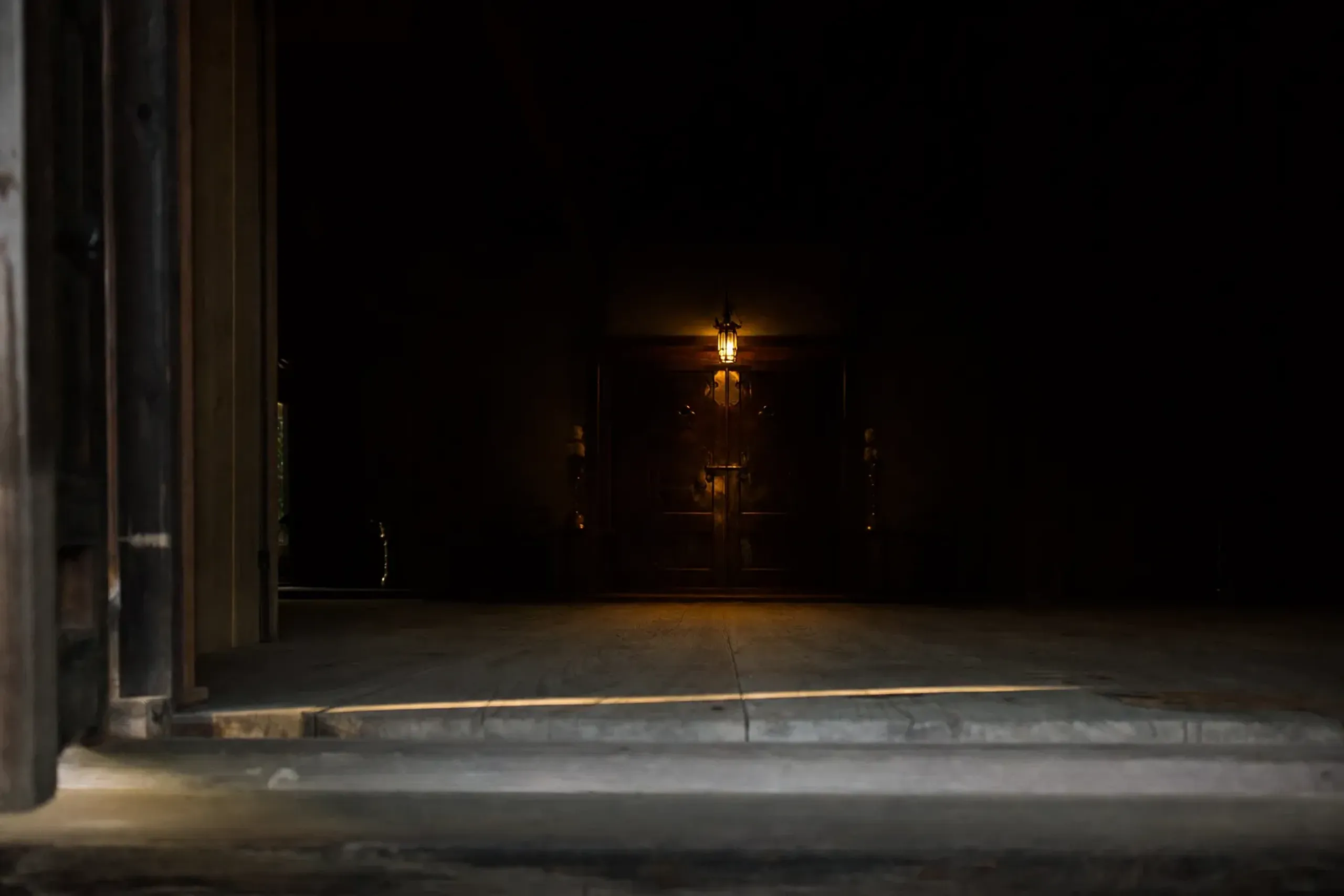 The dim interior threshold of the Main Hall's inner sanctuary (naijin) at Kiyomizu-dera, its central hibutsu shrine sealed and unseen behind closed doors